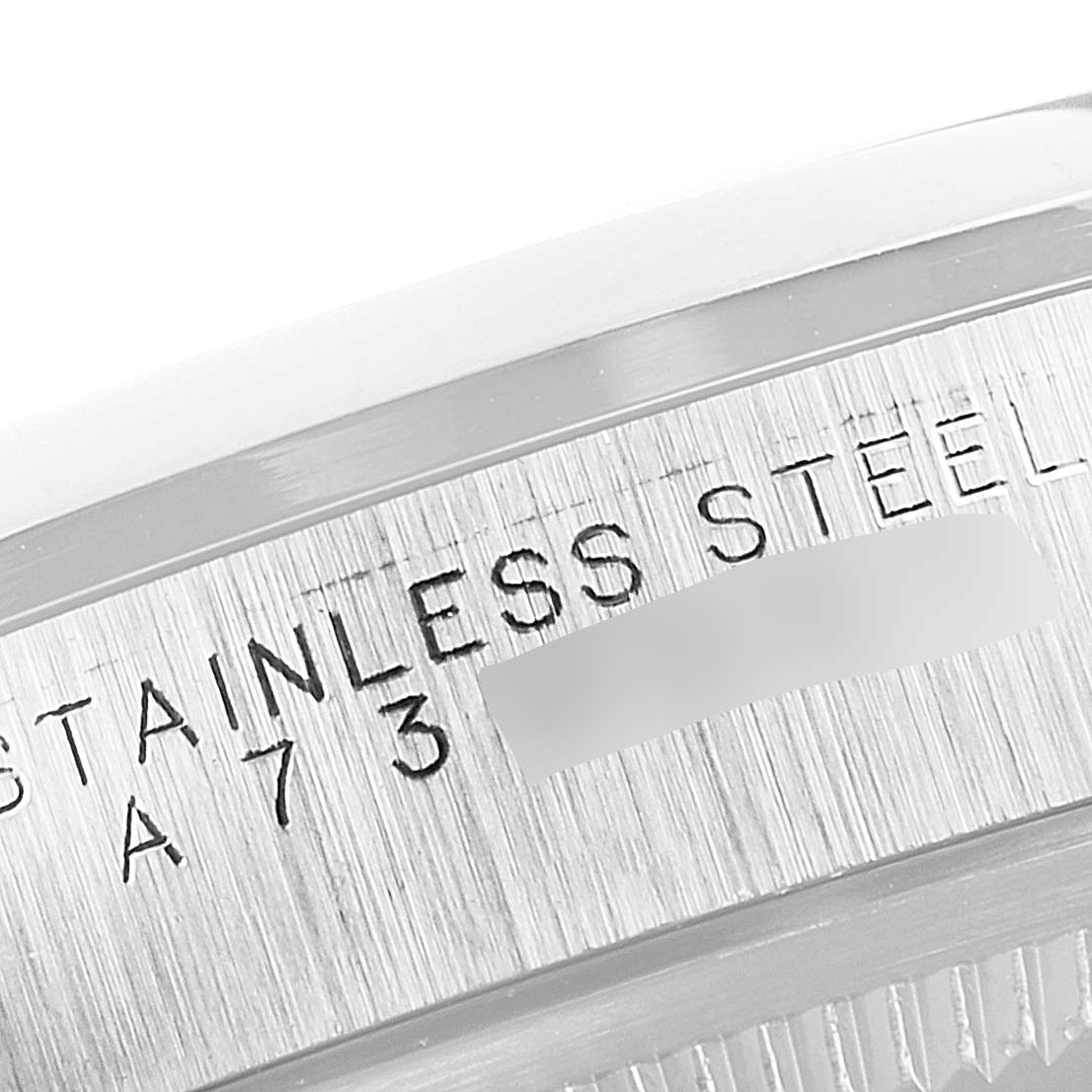 This is a close-up of the case back edge of a Rolex Explorer 14270 Men
s Stainless Steel Black Dial 14270 Men
s Stainless Steel Black Dial watch, showing the "Stainless Steel" engraving.