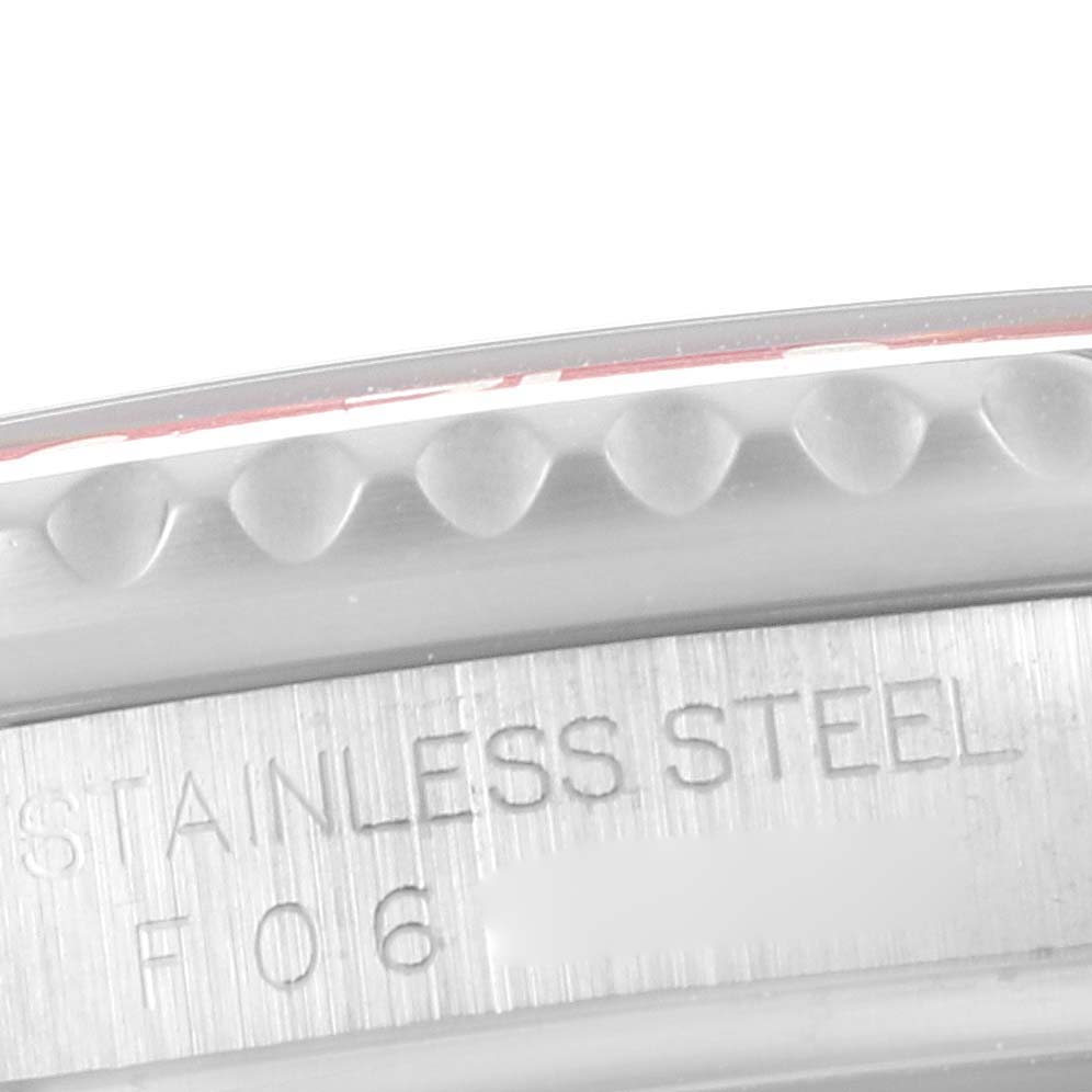 The image shows a close-up of the stainless steel bezel and part of the engraved serial number of a Rolex GMT-Master 16710 Men
s Stainless Steel Black Dial 16710 Men
s Stainless Steel Black Dial watch.