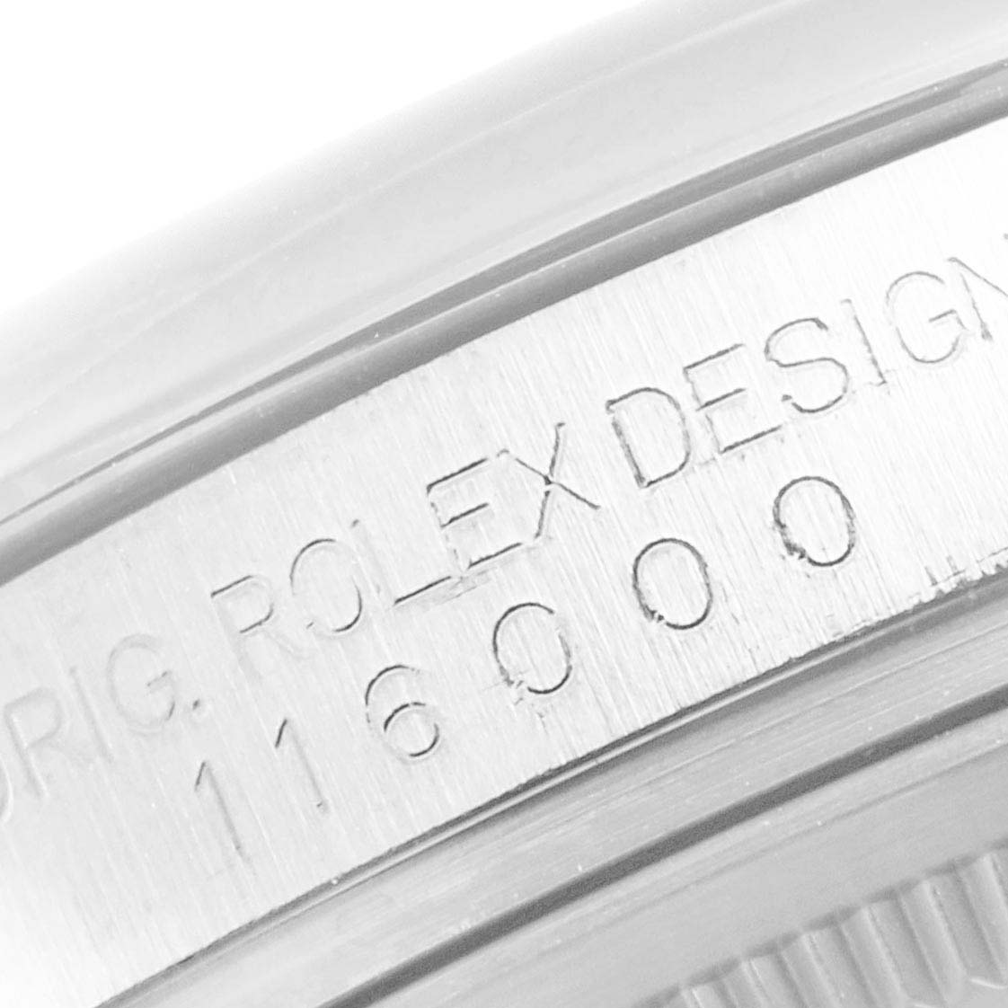 This image shows a close-up of the model number and branding on the side of a Rolex Oyster Perpetual 116000 Men's Stainless Steel Grey Dial 116000 Men's Stainless Steel Grey Dial watch.