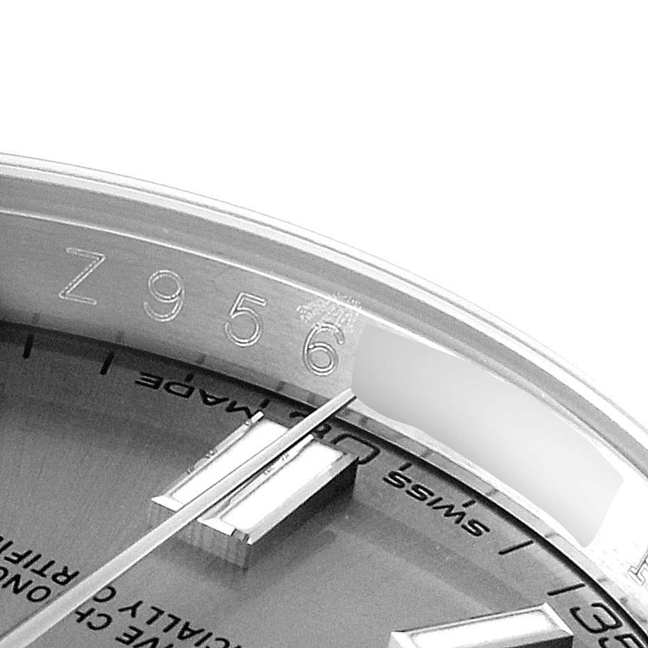 This image shows a close-up of the serial number and part of the dial for the Rolex Oyster Perpetual 116000 Men's Stainless Steel Grey Dial 116000 Men's Stainless Steel Grey Dial watch.