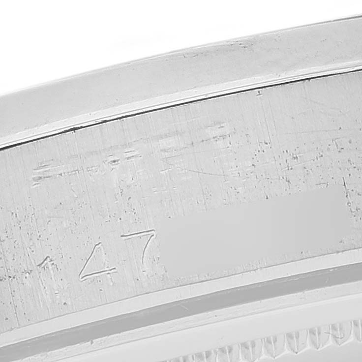 This image shows a close-up of the serial number engraving on the side of a Rolex Vintage Collection 6694 Men's Stainless Steel Black Dial 6694 Men's Stainless Steel Black Dial watch case.