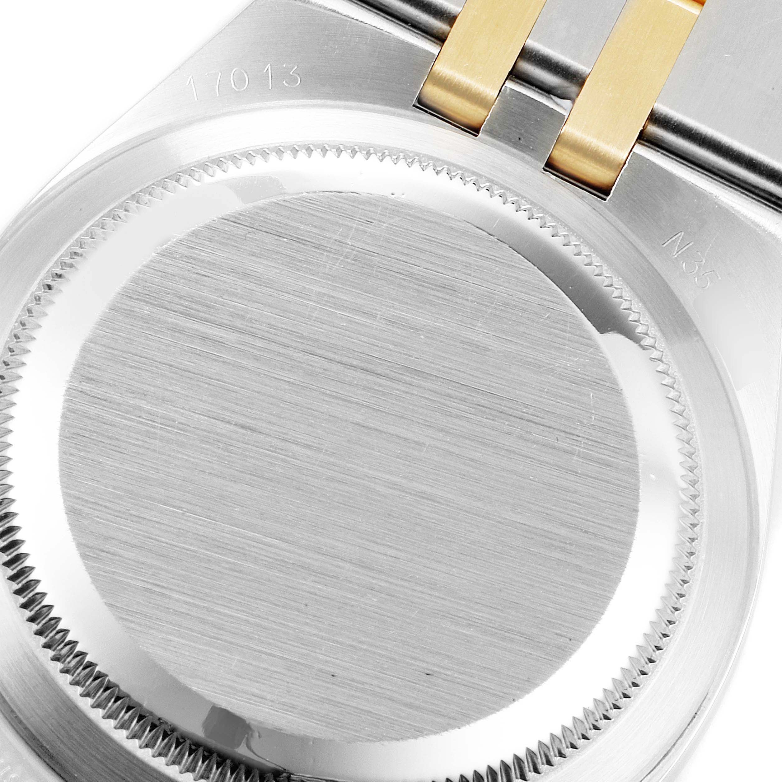 The image shows the back cover and part of the bracelet of a Rolex Oysterquartz 17013 Men's Steel and Gold (two tone) Champagne Dial 17013 Men's Steel and Gold (two tone) Champagne Dial watch model.