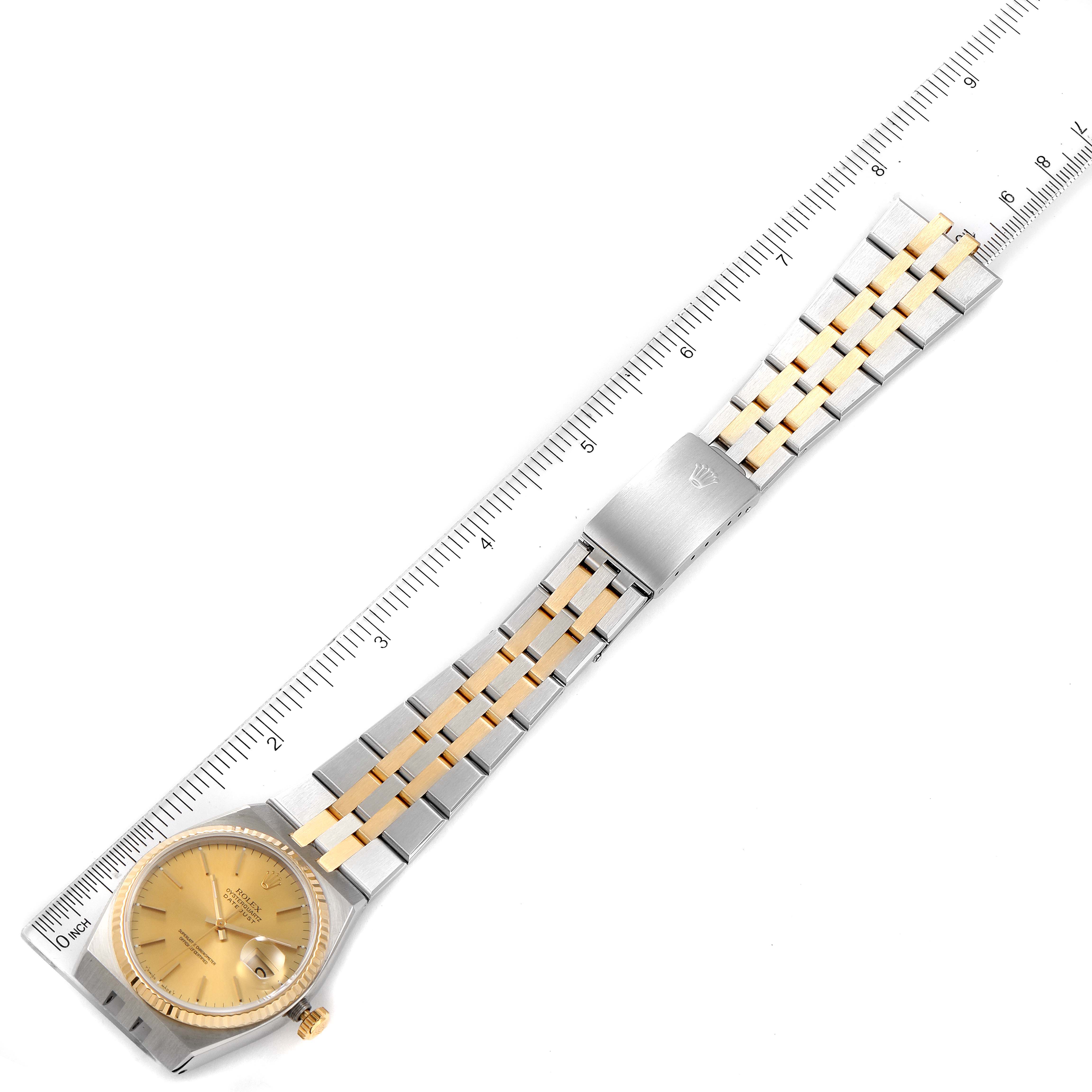 This image shows the full length of a Rolex Oysterquartz 17013 Men's Steel and Gold (two tone) Champagne Dial 17013 Men's Steel and Gold (two tone) Champagne Dial watch, including the dial, bracelet, and clasp, with a ruler for scale.