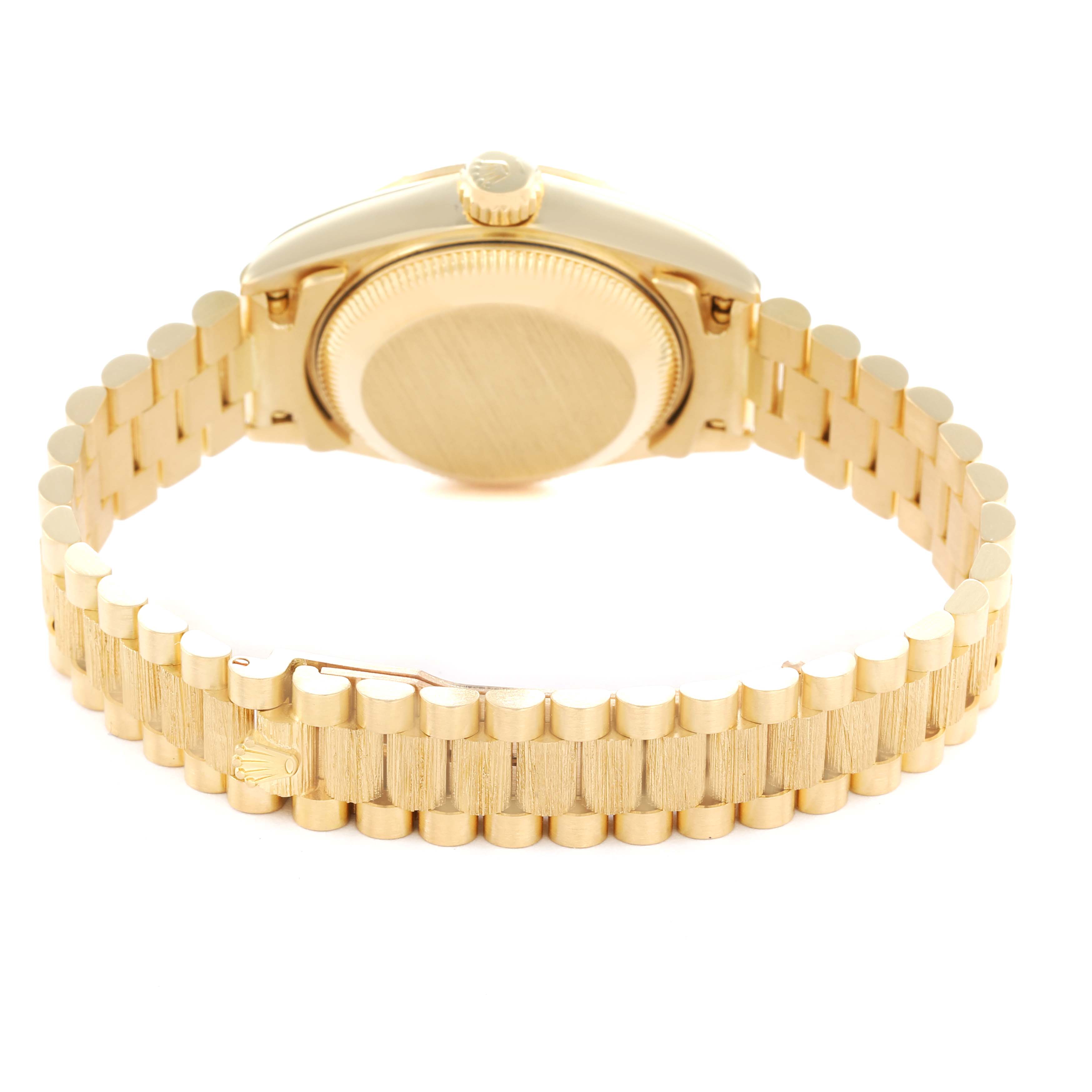 The image shows the back view of a Rolex President 69278 Women's Yellow Gold Champagne Dial model, highlighting the case back and the gold bracelet.