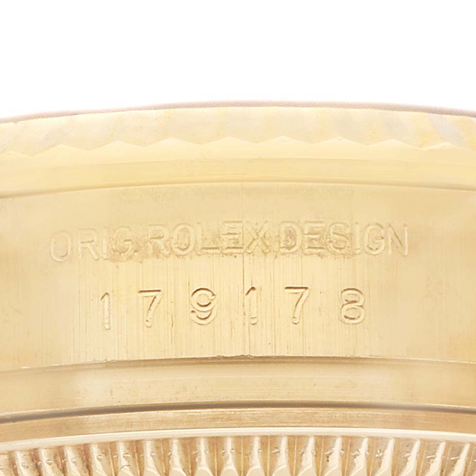 The image shows a close-up of the Rolex President 179178 Women's Yellow Gold Champagne Dial watch's inner bezel with model and design engravings.