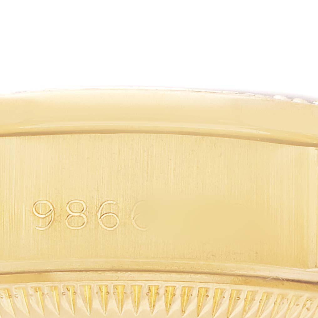 The image shows a close-up side view of the gold case and serial number of a Rolex President 69158 Women's Yellow Gold Champagne Dial watch.