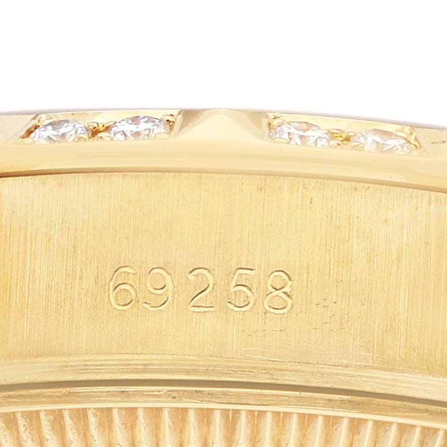 The image shows a close-up of the model number engraved on the case edge of a Rolex President 69258 Women's Yellow Gold Champagne Dial watch with a glimpse of a diamond-set bezel.