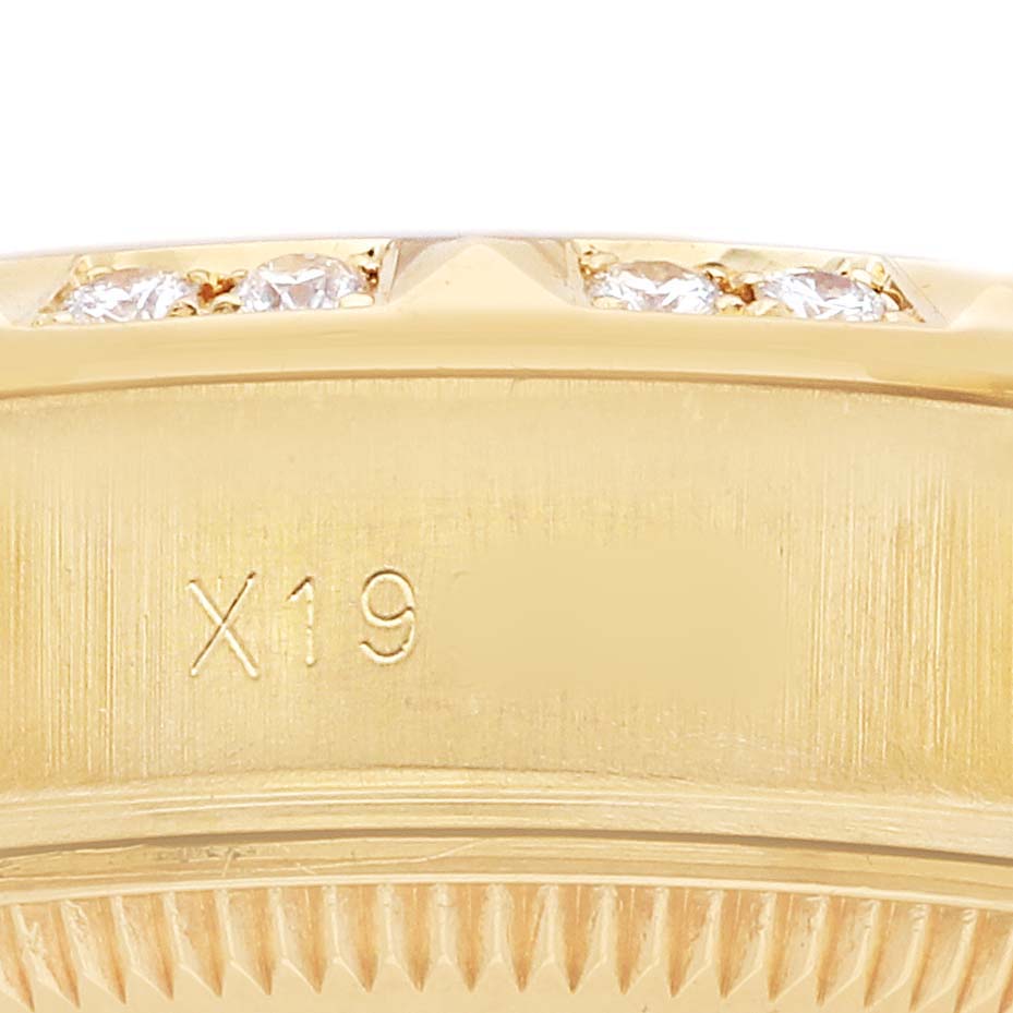 The image shows a close-up of the side of a Rolex President 69258 Women's Yellow Gold Champagne Dial model, highlighting the bezel with embedded diamonds and part of the case edge.