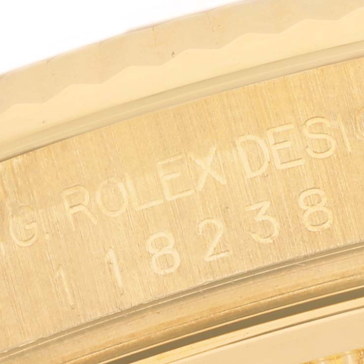 The image shows a close-up of the side of a Rolex President 118238 Men's Yellow Gold Mother of Pearl Dial 118238 Men's Yellow Gold Mother of Pearl Dial watch with engraved numbers and "ROLEX DESIGN."