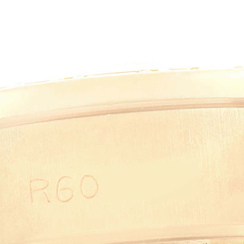 The image shows a close-up of an engraved inner bezel of a Rolex President 69068 Women
s Yellow Gold Champagne Dial 69068 Women
s Yellow Gold Champagne Dial watch.