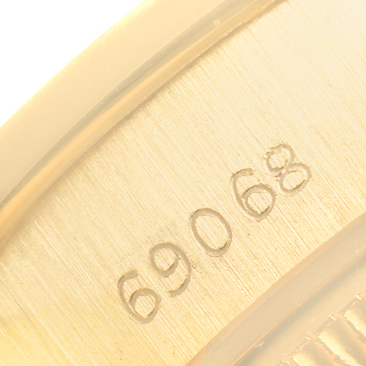 This close-up image shows the engraved model number "69068" on a Rolex President 69068 Women
s Yellow Gold Champagne Dial 69068 Women
s Yellow Gold Champagne Dial watch.