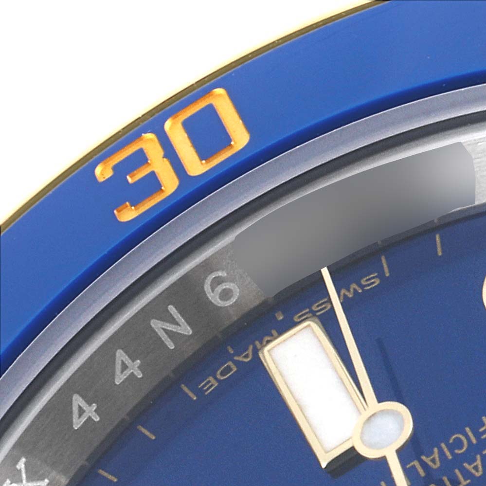 The image shows a close-up of the bezel and part of the dial of a Rolex Submariner 116613 Men's Steel and Gold (two tone) Blue Dial 116613 Men's Steel and Gold (two tone) Blue Dial watch.