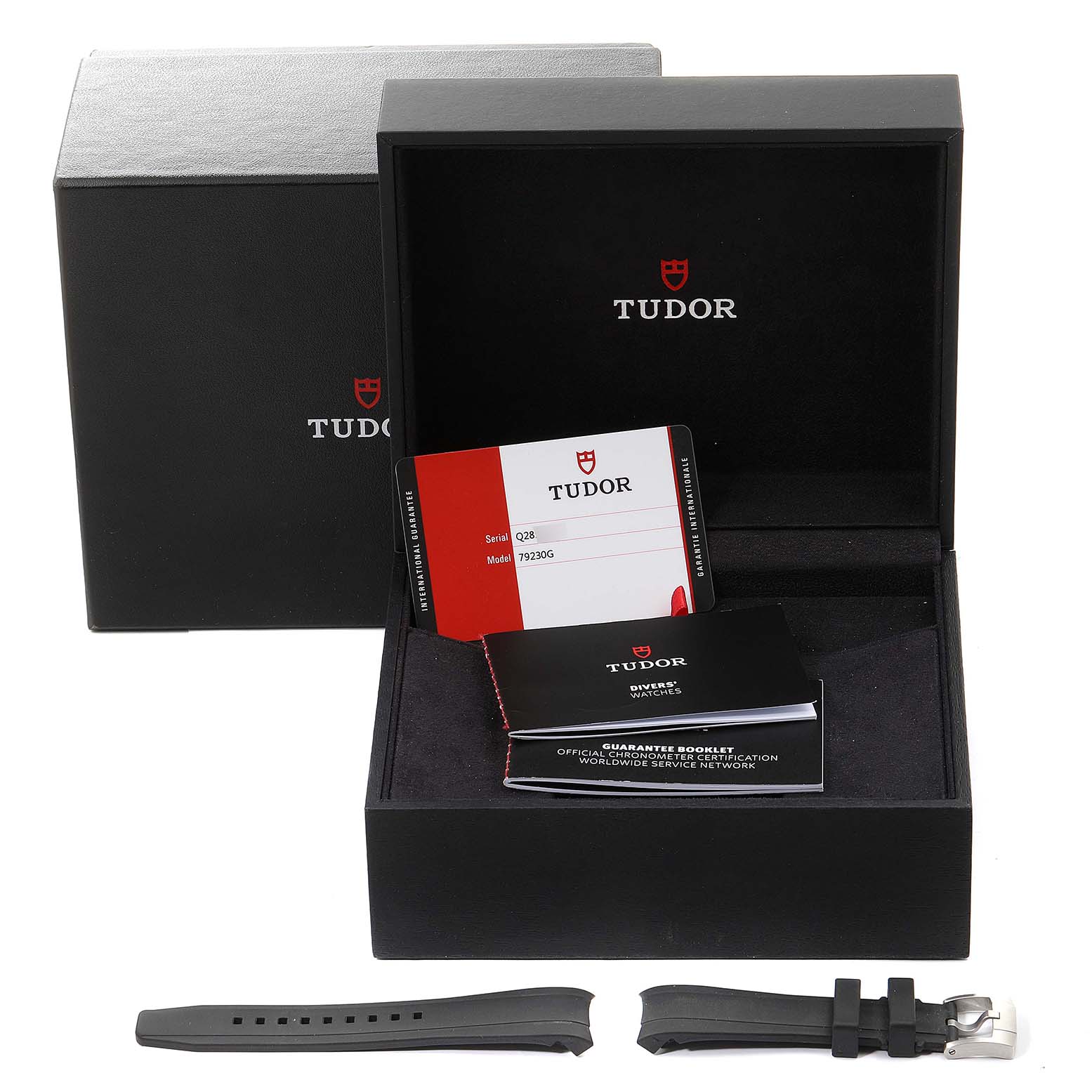 The picture shows the Tudor Heritage Black Bay 79230G Men
s Stainless Steel Black Dial 79230G Men
s Stainless Steel Black Dial packaging, including the box, booklets, warranty card, and extra straps.