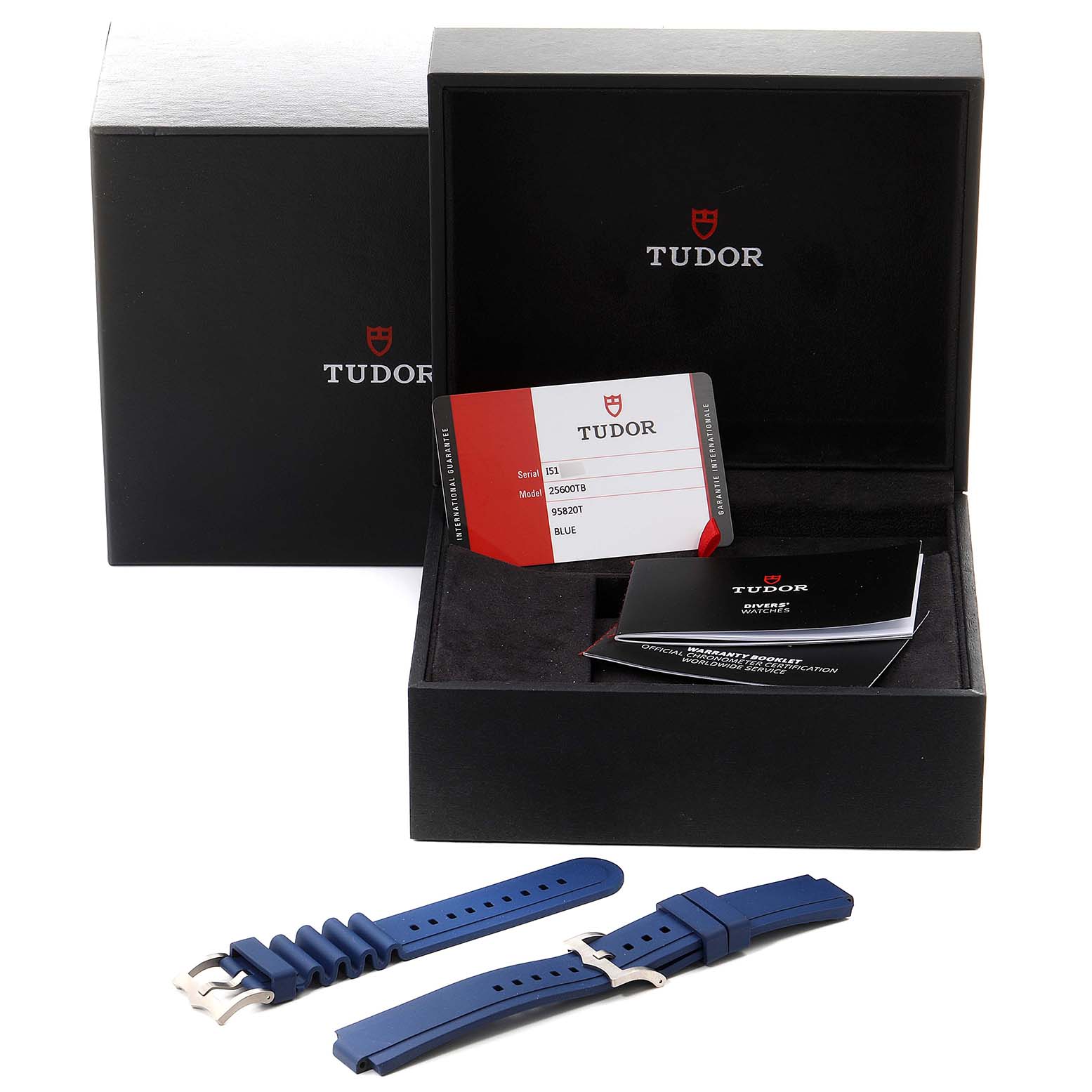 The image shows the packaging, warranty card, manual, and blue replacement straps for the Tudor Pelagos 25600TV Men's Titanium Blue Dial 25600TV Men's Titanium Blue Dial watch.