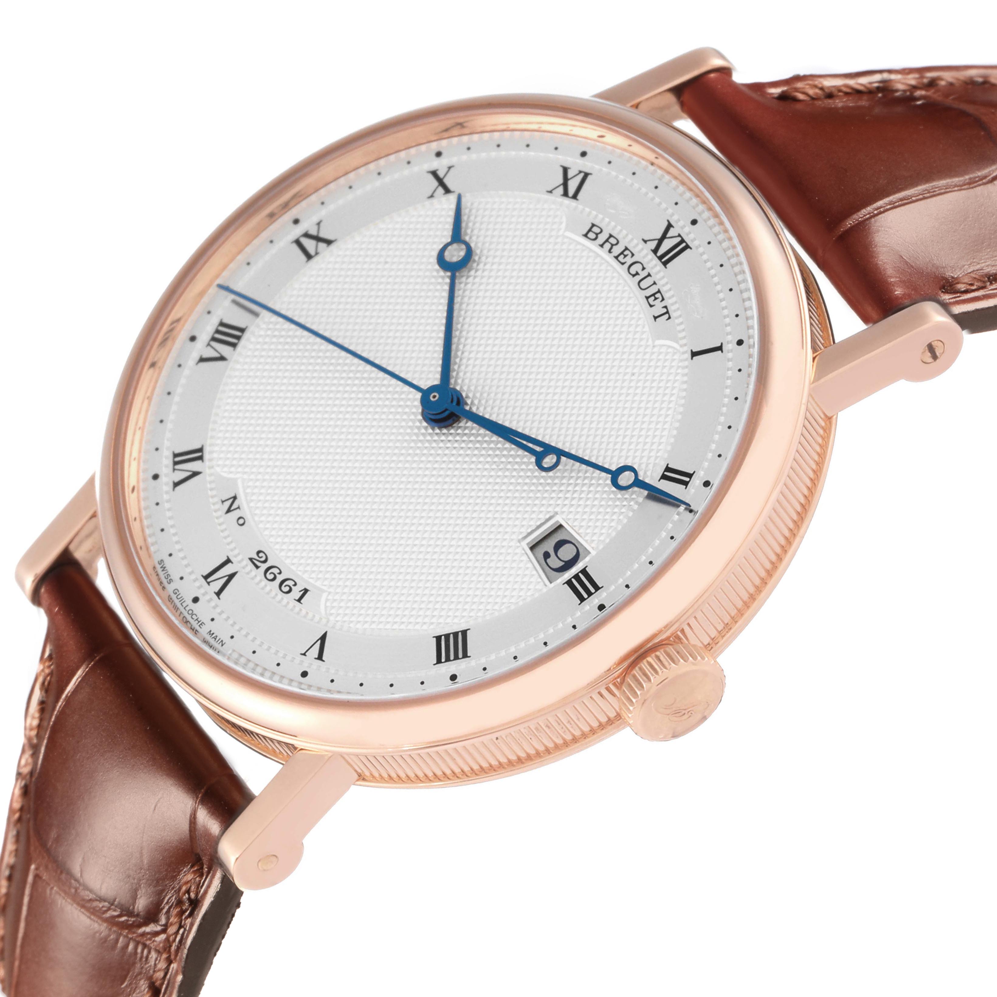The Breguet Classique 5177BR/12/9V6 Men's Rose Gold Silver Dial 5177BR/12/9V6 Men's Rose Gold Silver Dial watch is angled to show its dial, crown, and a portion of the brown leather strap.