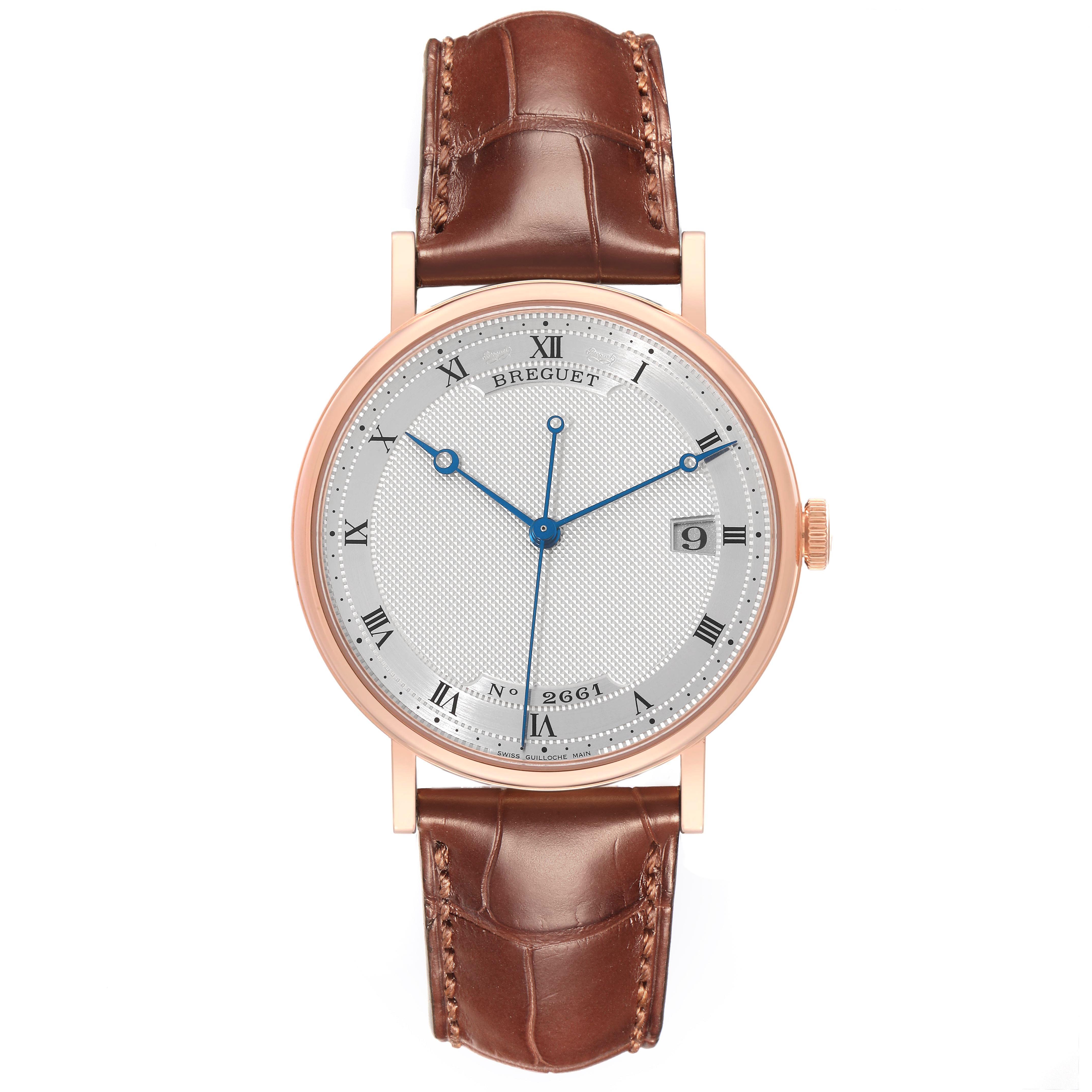 The Breguet Classique 5177BR/12/9V6 Men's Rose Gold Silver Dial 5177BR/12/9V6 Men's Rose Gold Silver Dial watch is shown from the front, highlighting its round face, Roman numerals, blue hands, and brown leather strap.