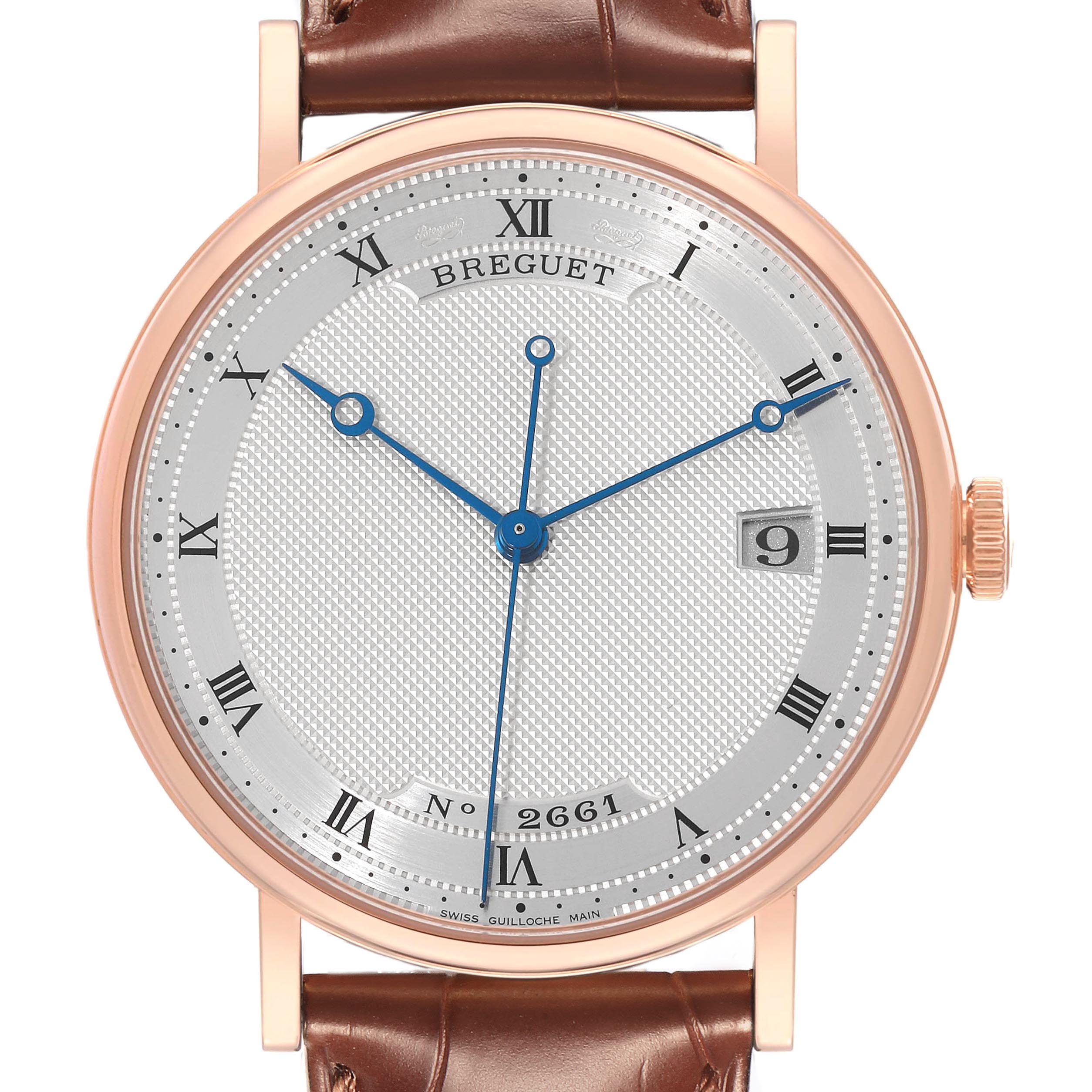The Breguet Classique 5177BR/12/9V6 Men's Rose Gold Silver Dial 5177BR/12/9V6 Men's Rose Gold Silver Dial watch is shown from the front, highlighting the dial, hands, and part of the leather strap.