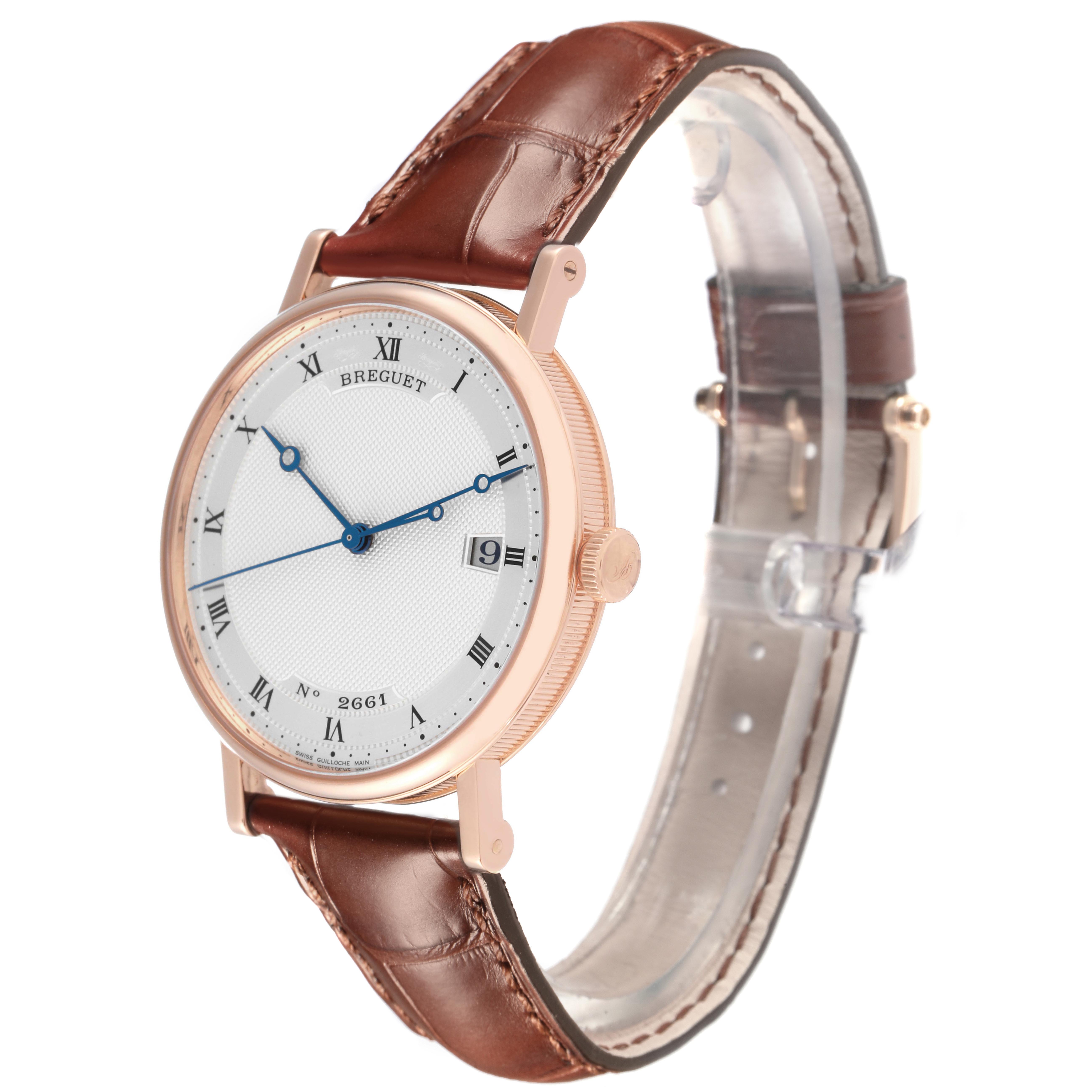 The Breguet Classique 5177BR/12/9V6 Men's Rose Gold Silver Dial 5177BR/12/9V6 Men's Rose Gold Silver Dial watch is shown at a slight angle, highlighting its face, crown, and part of the leather strap.