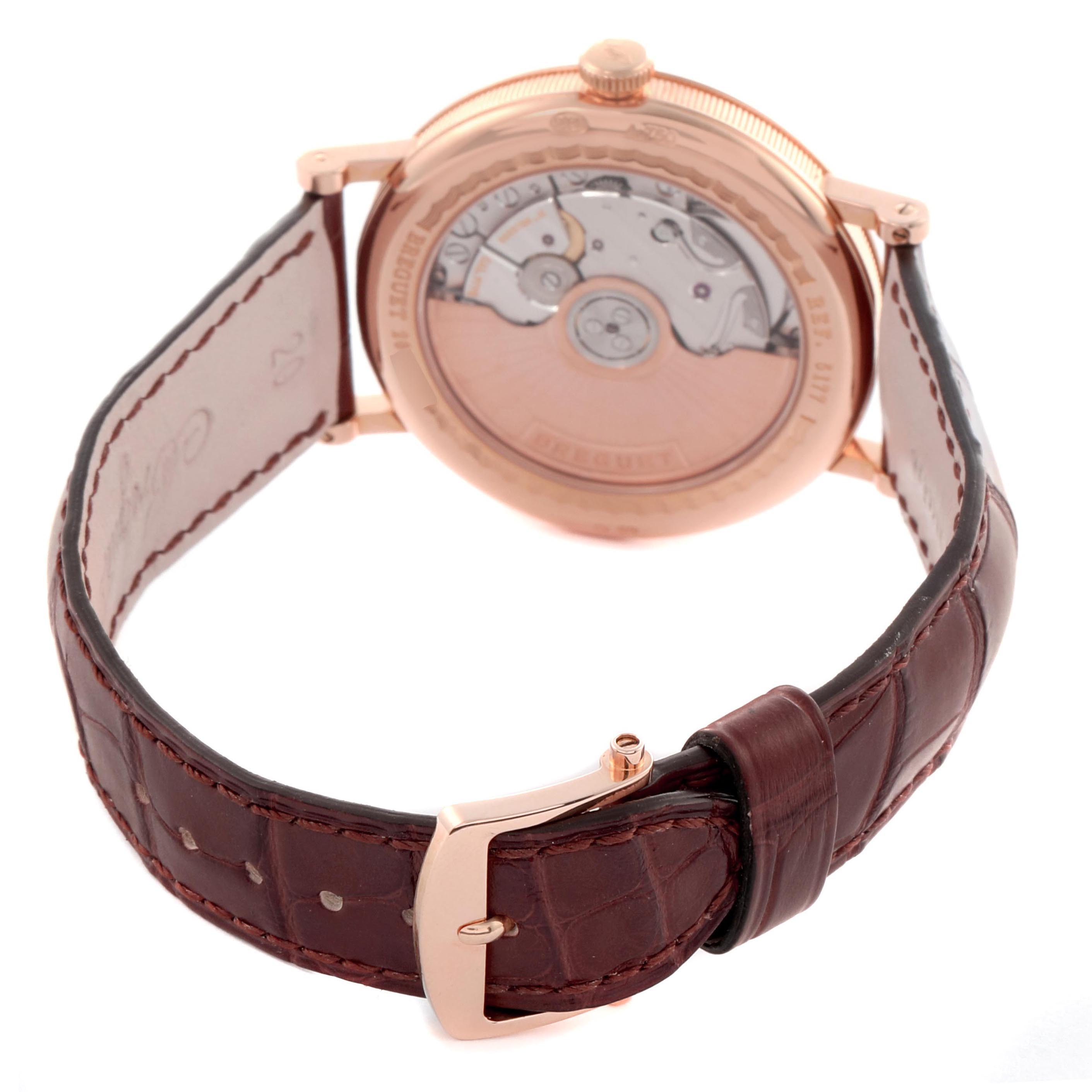 The Breguet Classique 5177BR/12/9V6 Men's Rose Gold Silver Dial 5177BR/12/9V6 Men's Rose Gold Silver Dial watch is shown from the back, highlighting the case back, movement, and leather strap.