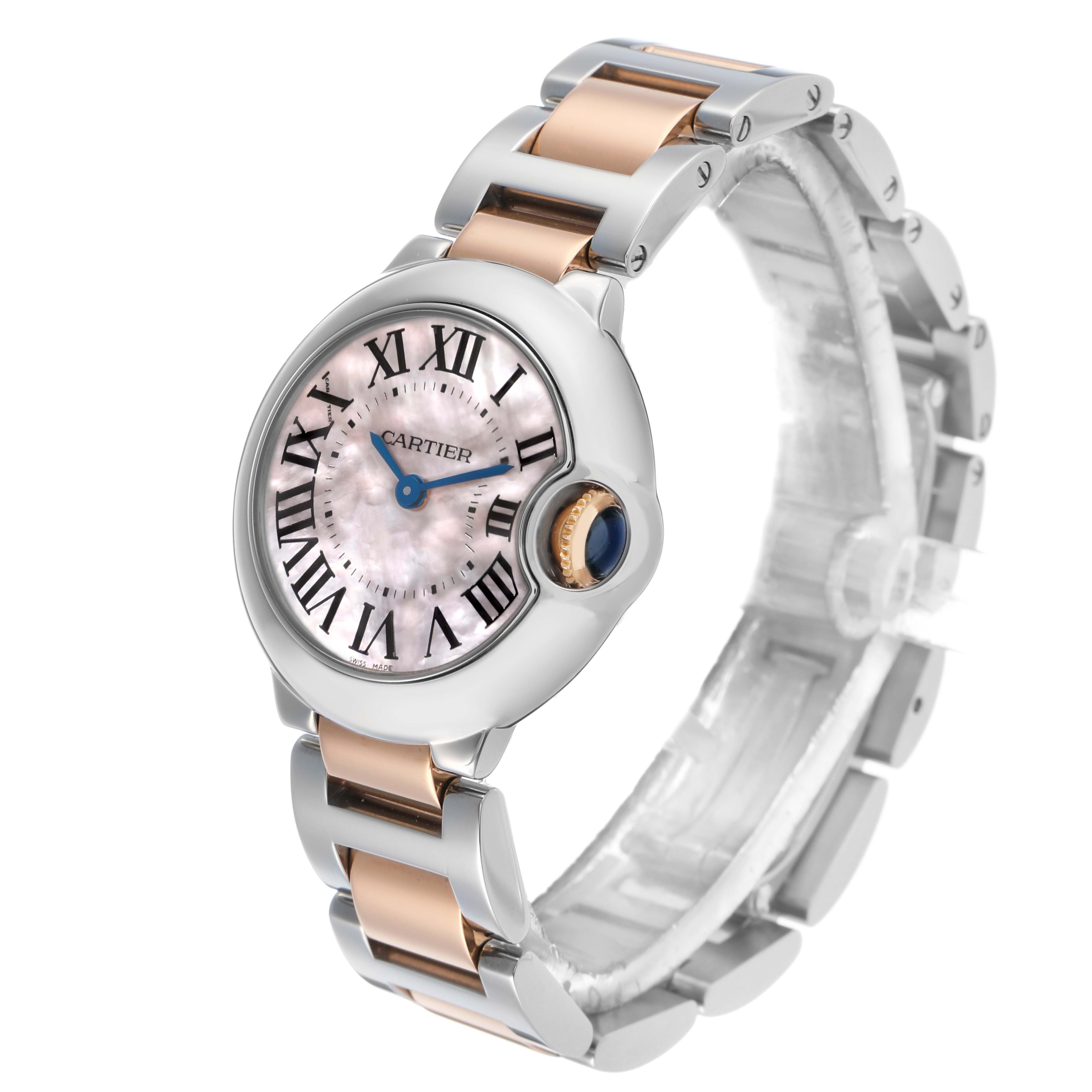 The Cartier Ballon Bleu W6920034 Women's Steel and Gold (two tone) Mother of Pearl Dial watch is shown at a 3/4 angle, displaying its dial, crown, and two-tone bracelet.