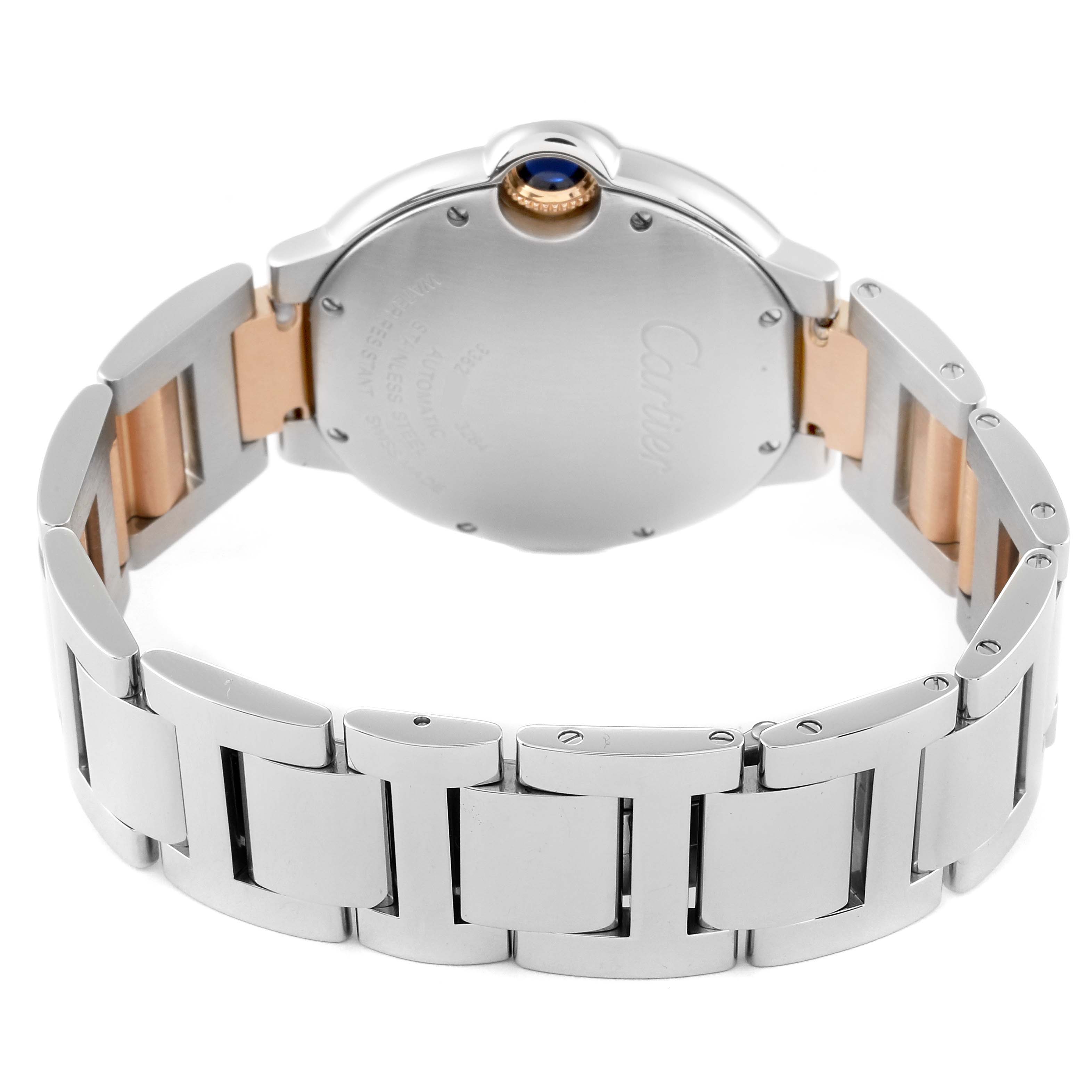 The image shows the back case and bracelet of a Cartier Ballon Bleu W3BB0018 Women
s Steel and Gold (two tone) Silver Dial W3BB0018 Women
s Steel and Gold (two tone) Silver Dial watch at an angle that focuses on the rear side.