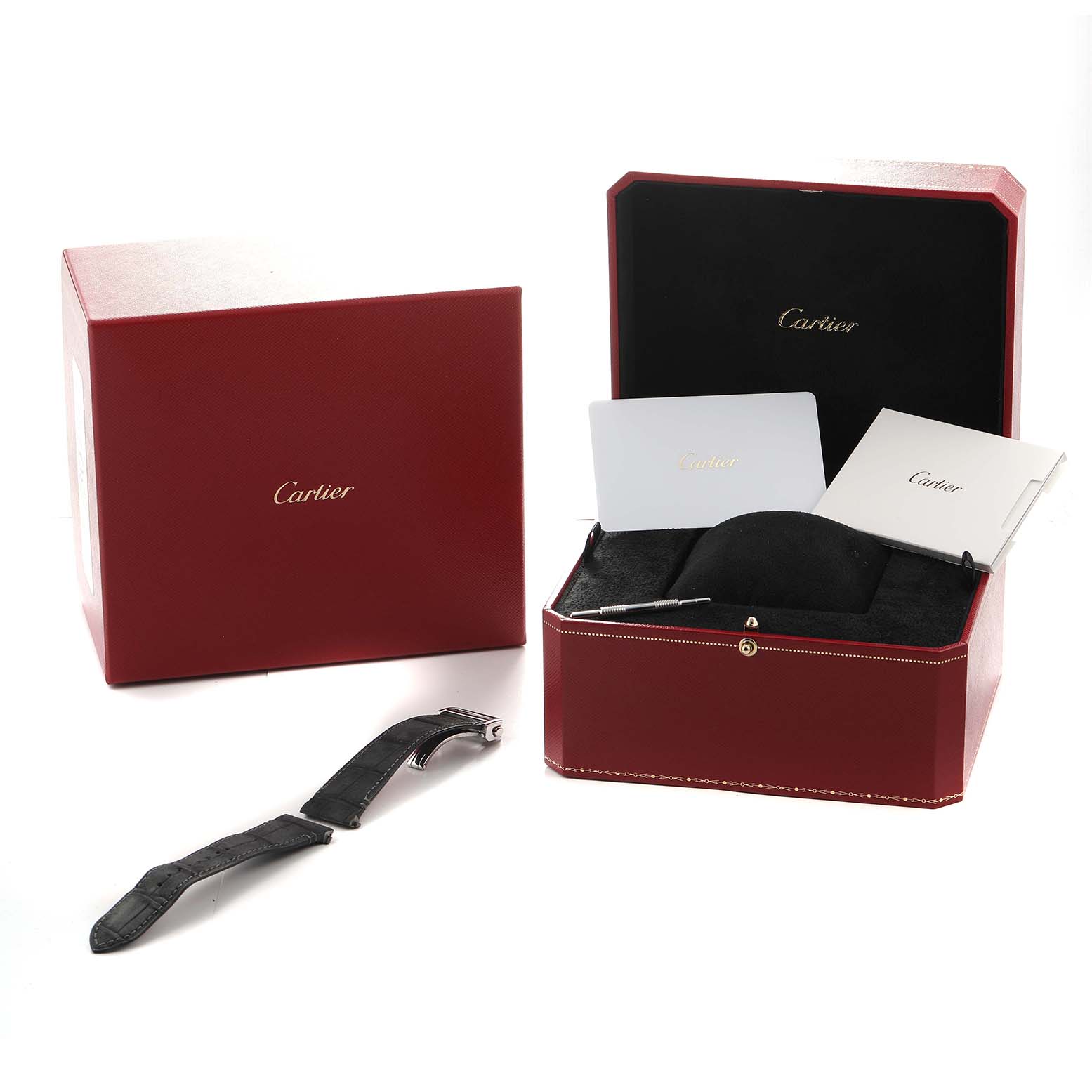 The image shows a Cartier Santos WSSA0076 Men's Stainless Steel Grey Dial watch box with documents, a strap, and a tool at a high angle.