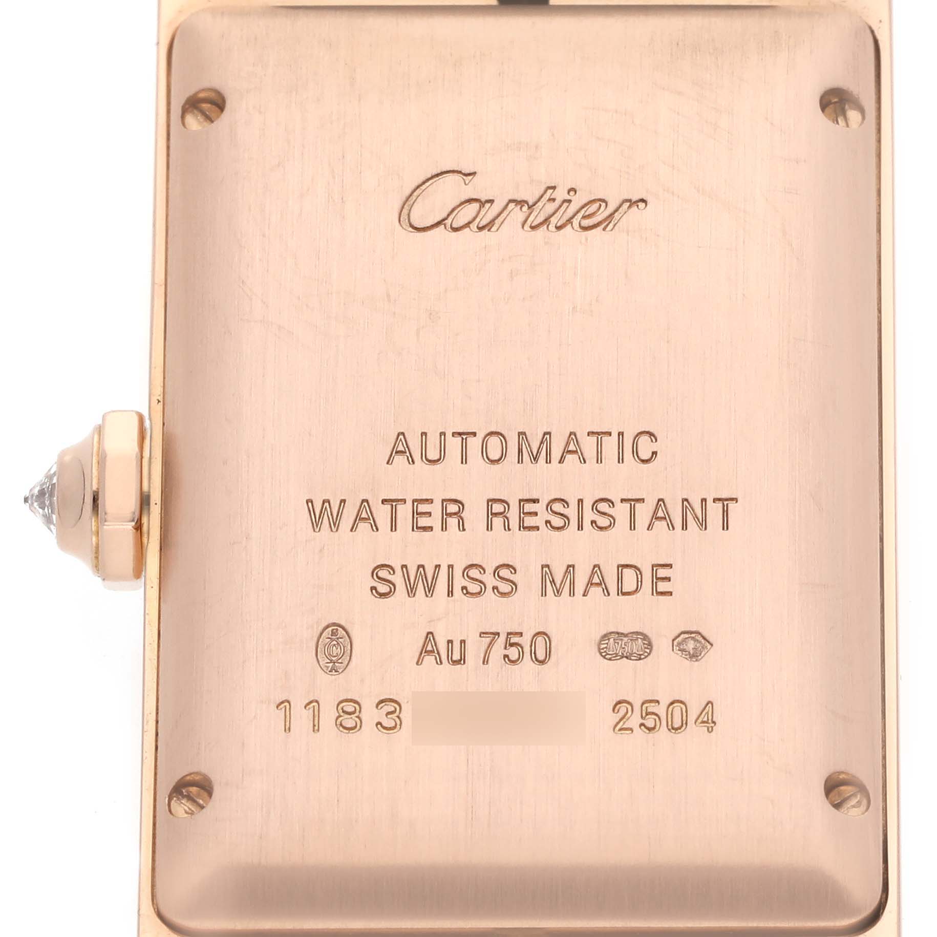 The image shows the back case of a Cartier Tank Américaine watch, displaying engravings and markings.