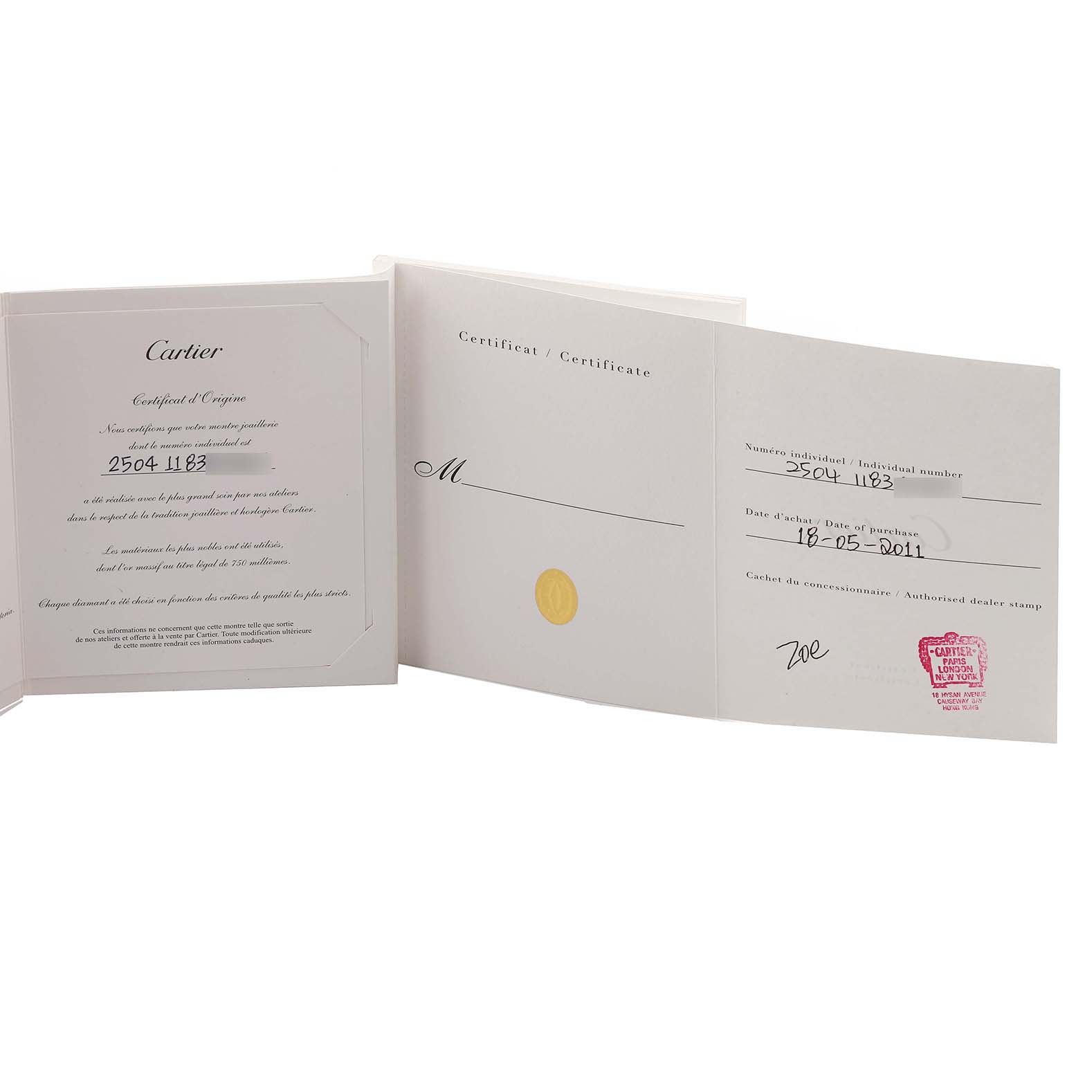 The image shows certificates or documentation for the Cartier Tank Américaine watch, positioned slightly open and upright.