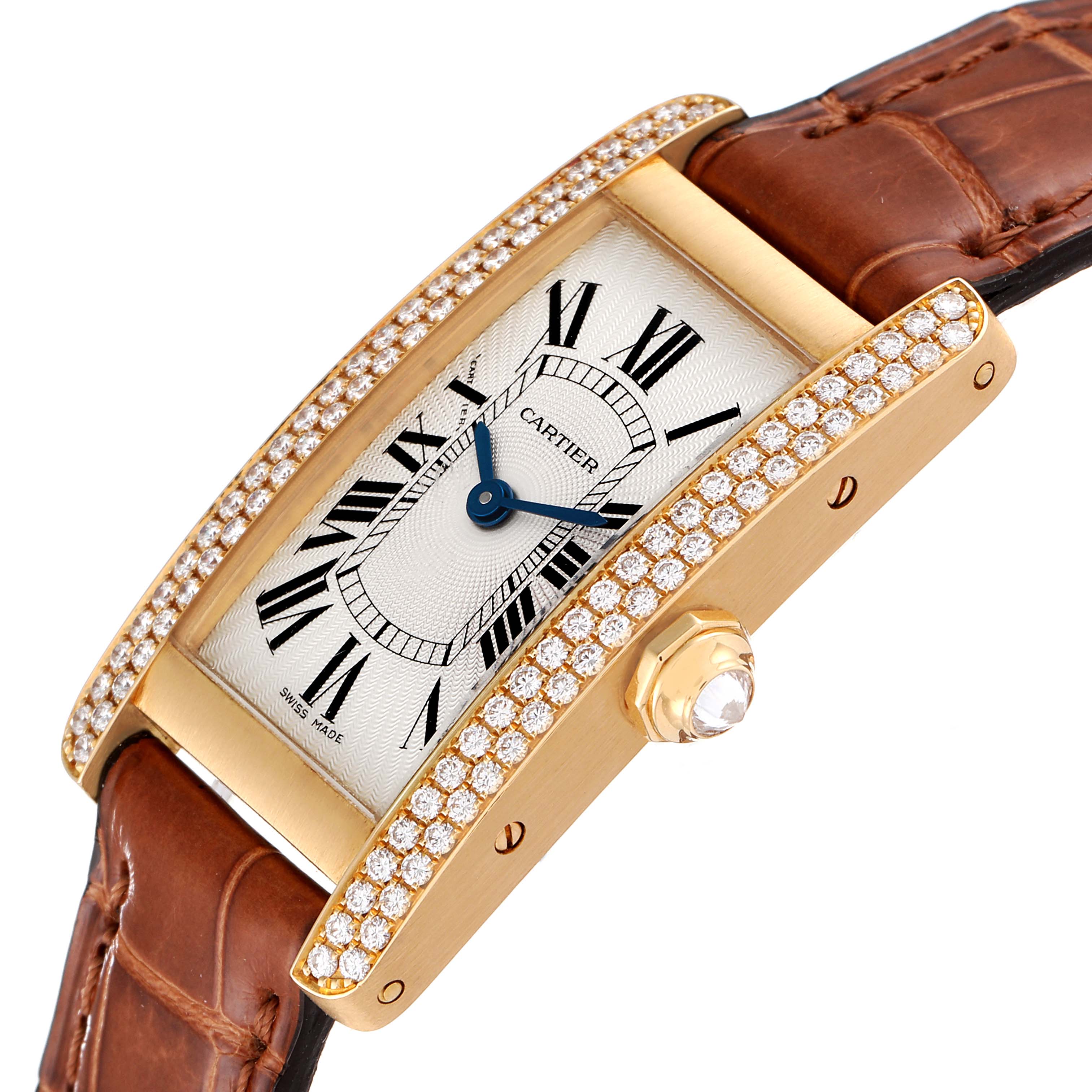The image shows a Cartier Tank Americaine WB701251 Women's Yellow Gold Silver Dial WB701251 Women's Yellow Gold Silver Dial watch at an angle highlighting the face, diamond-encrusted bezel, and leather strap.