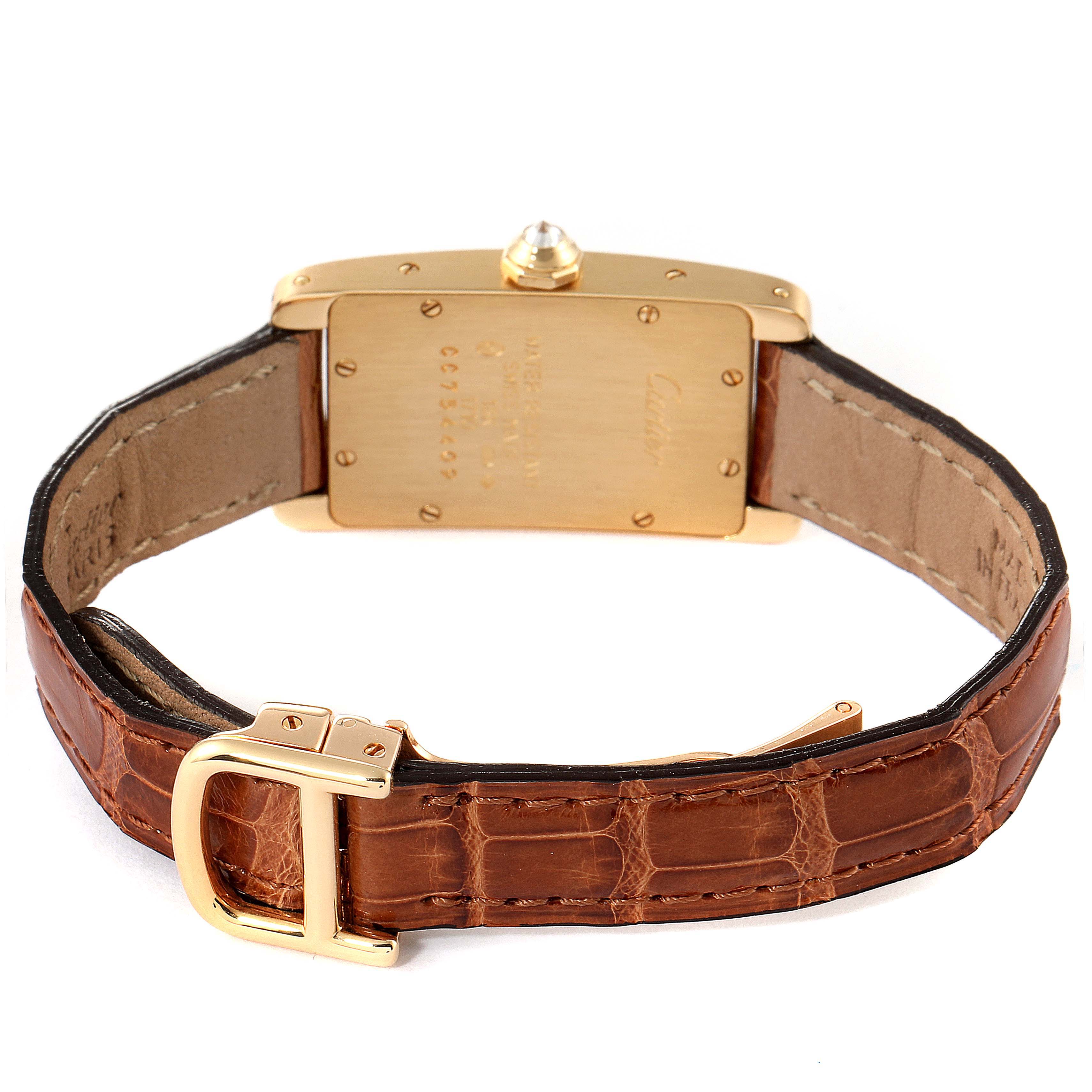 The image shows the back view of a Cartier Tank Américaine watch, revealing the case back and brown leather strap.