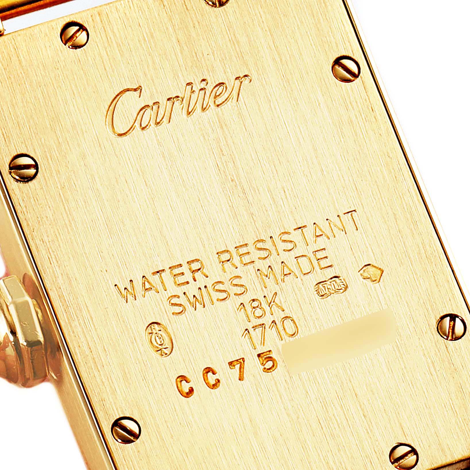 This is the back view of a Cartier Tank Americaine WB701251 Women's Yellow Gold Silver Dial WB701251 Women's Yellow Gold Silver Dial watch showing the engraved details and screws.