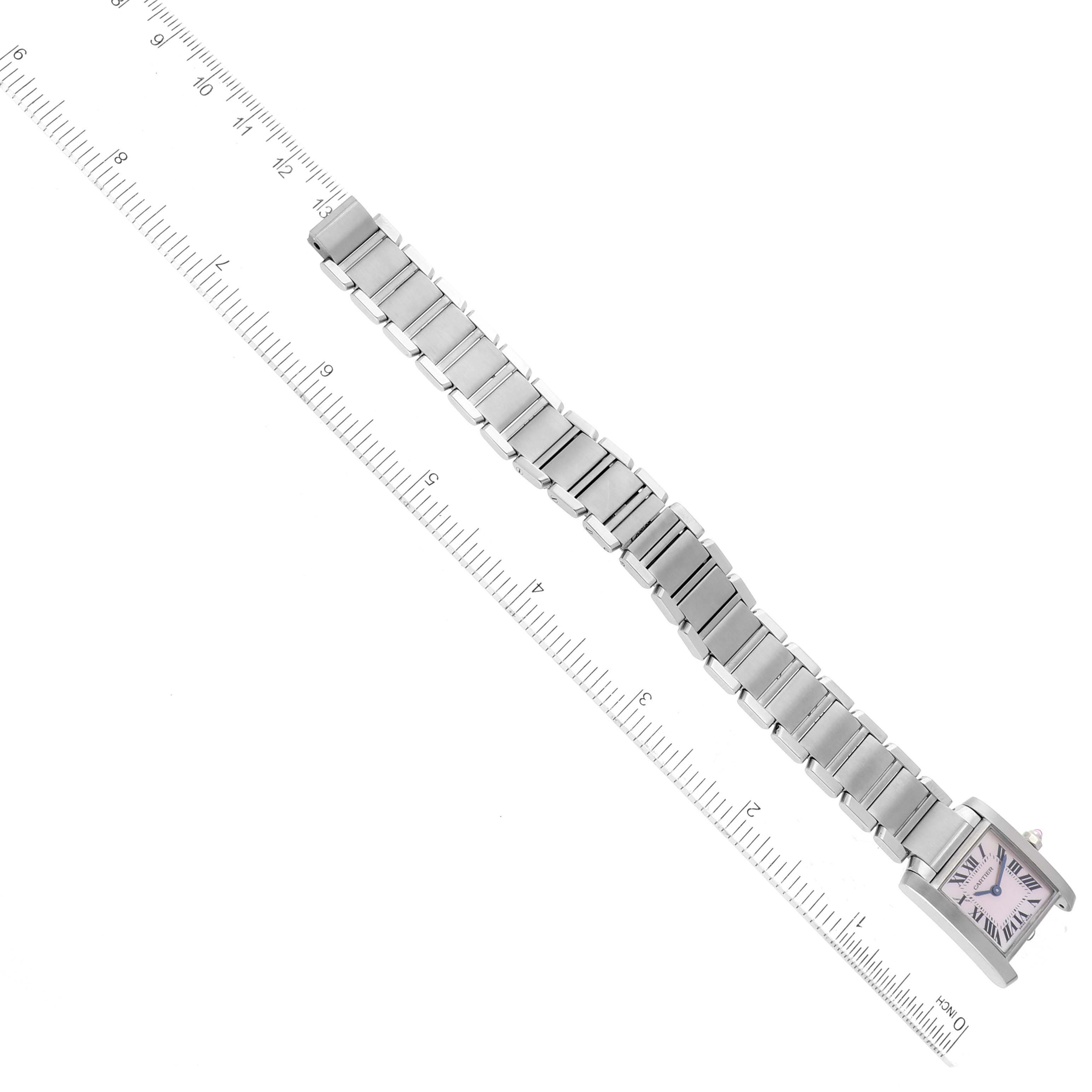 This image shows a top-down view of a Cartier Tank Francaise W51028Q3 Women's Stainless Steel Mother of Pearl Dial W51028Q3 Women's Stainless Steel Mother of Pearl Dial watch with its metal band extended alongside a ruler.