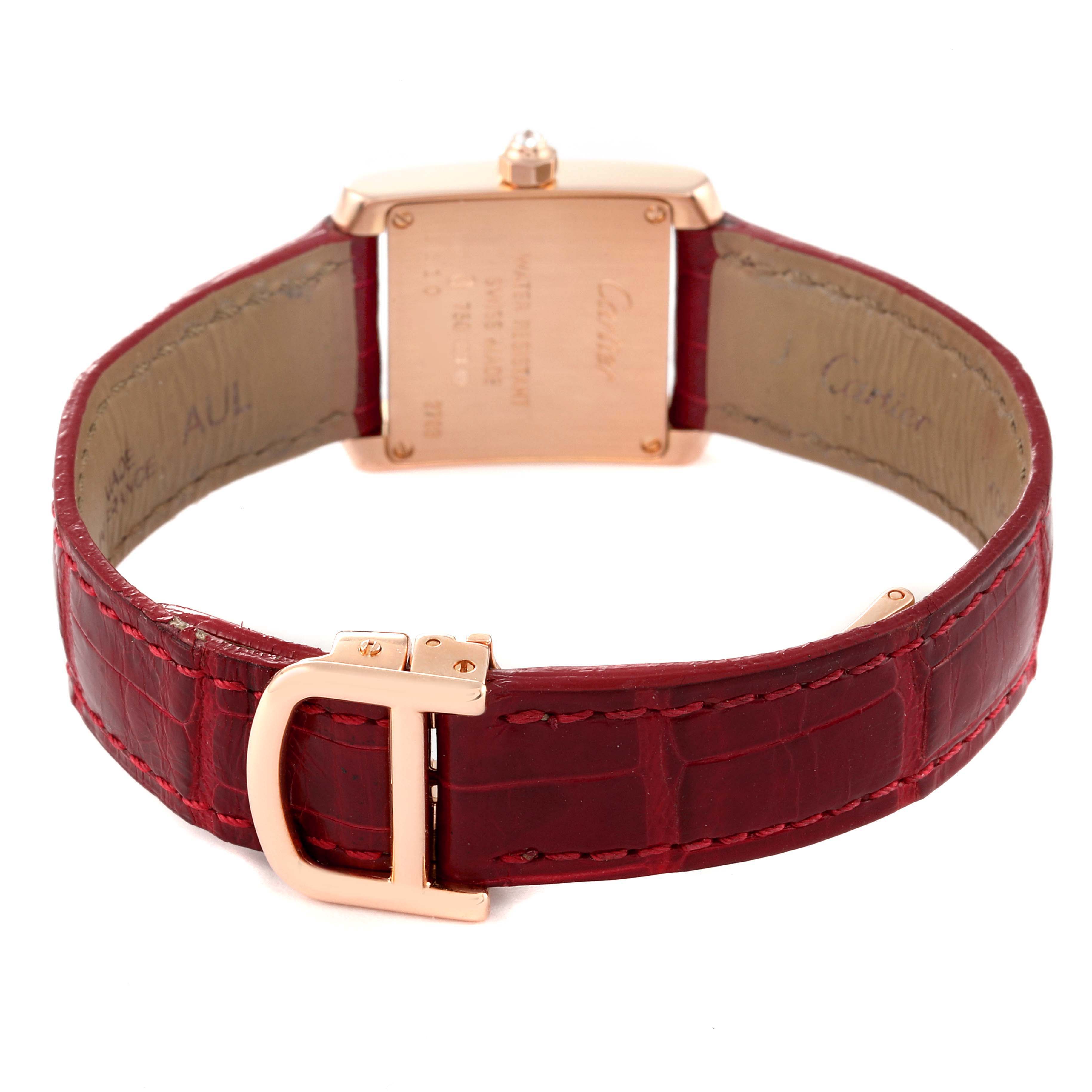 The image shows the back of a Cartier Tank Française watch with a red leather strap and gold buckle.