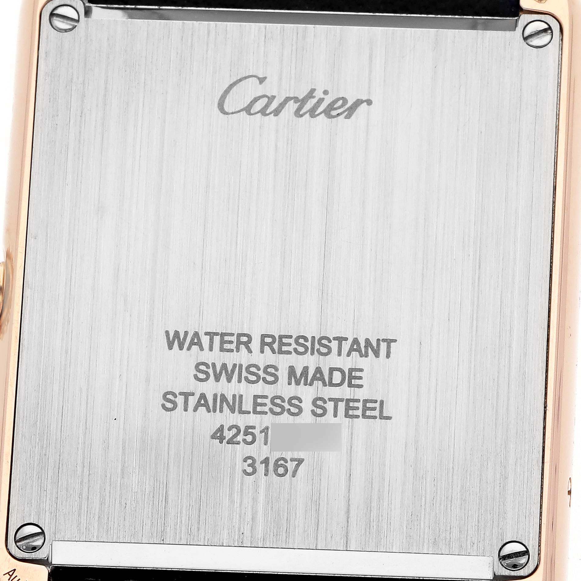 The image shows the case back of a Cartier Tank Solo W5200025 Men's Steel and Gold (two tone) Silver Dial watch, highlighting its stainless steel material and markings.