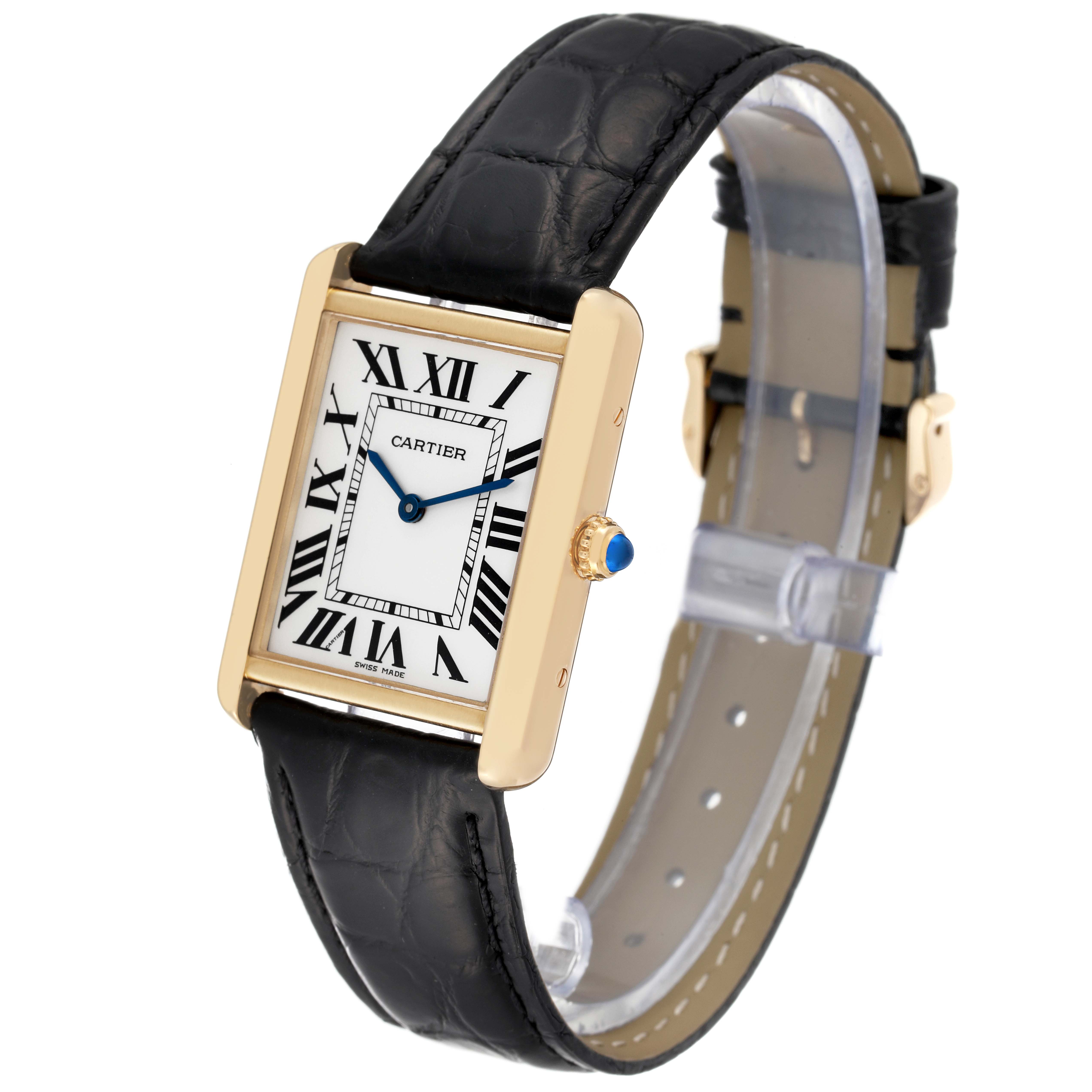 This Cartier Tank Solo W5200004 Men
s Steel and Gold (two tone) Silver Dial W5200004 Men
s Steel and Gold (two tone) Silver Dial watch is shown at an angle highlighting its rectangular dial, gold case, black leather strap, and blue cabochon crown.