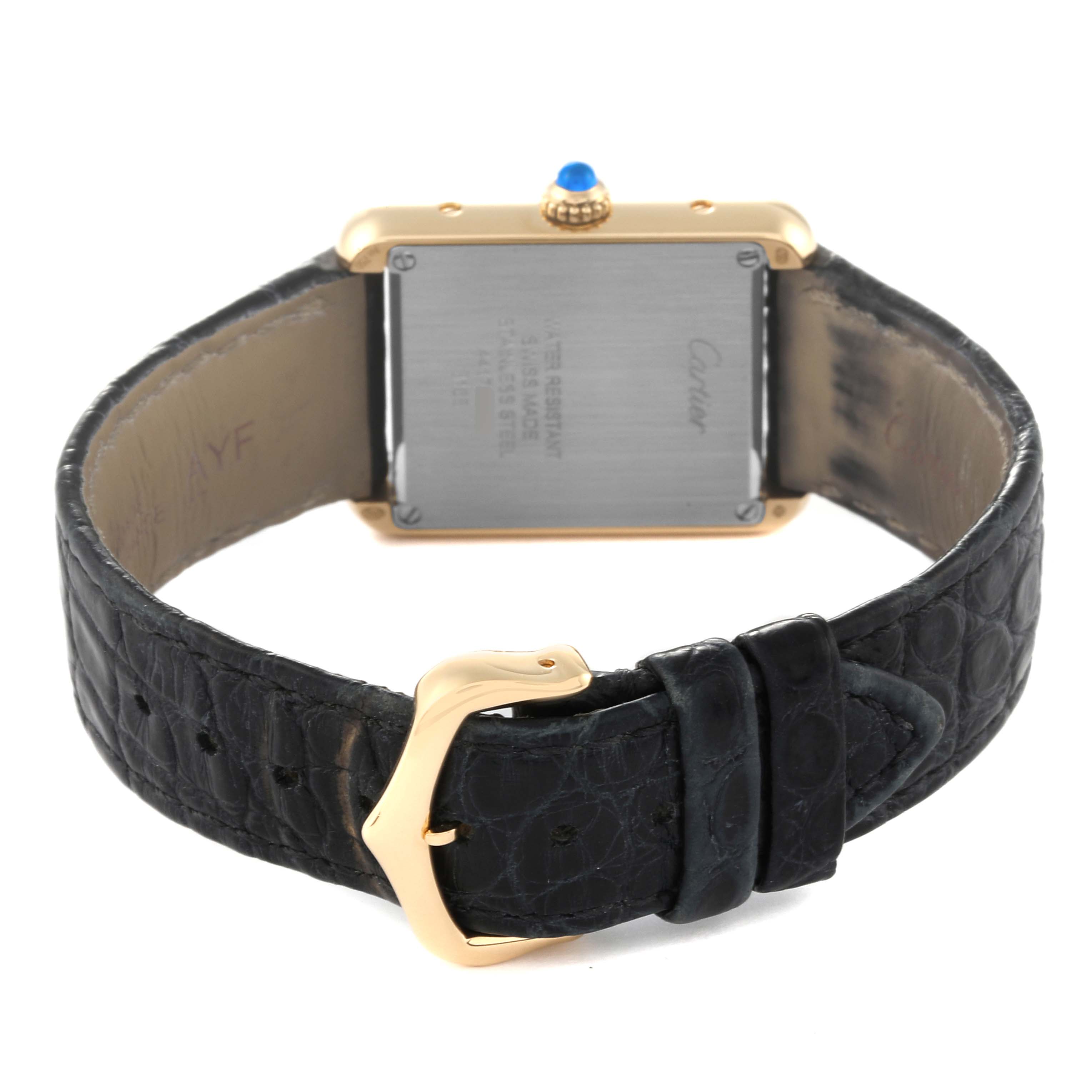 The image shows the back of the Cartier Tank Solo W5200002 Women
s Steel and Gold (two tone) Silver Dial W5200002 Women
s Steel and Gold (two tone) Silver Dial watch, focusing on its strap and buckle clasp.