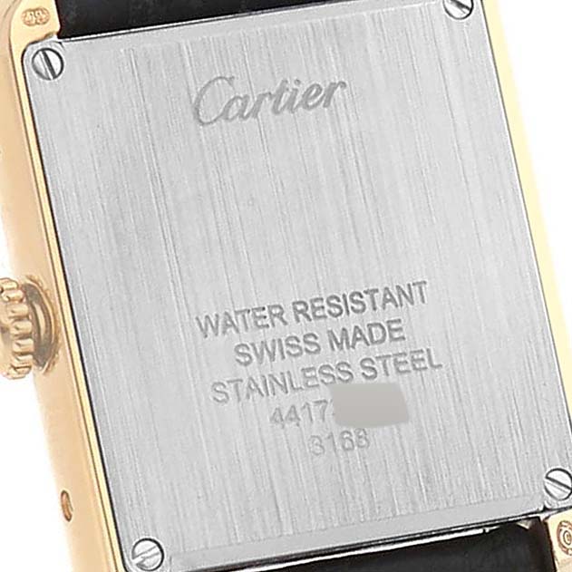 The image shows the back case of a Cartier Tank Solo W5200002 Women
s Steel and Gold (two tone) Silver Dial W5200002 Women
s Steel and Gold (two tone) Silver Dial watch, including the crown and screws.