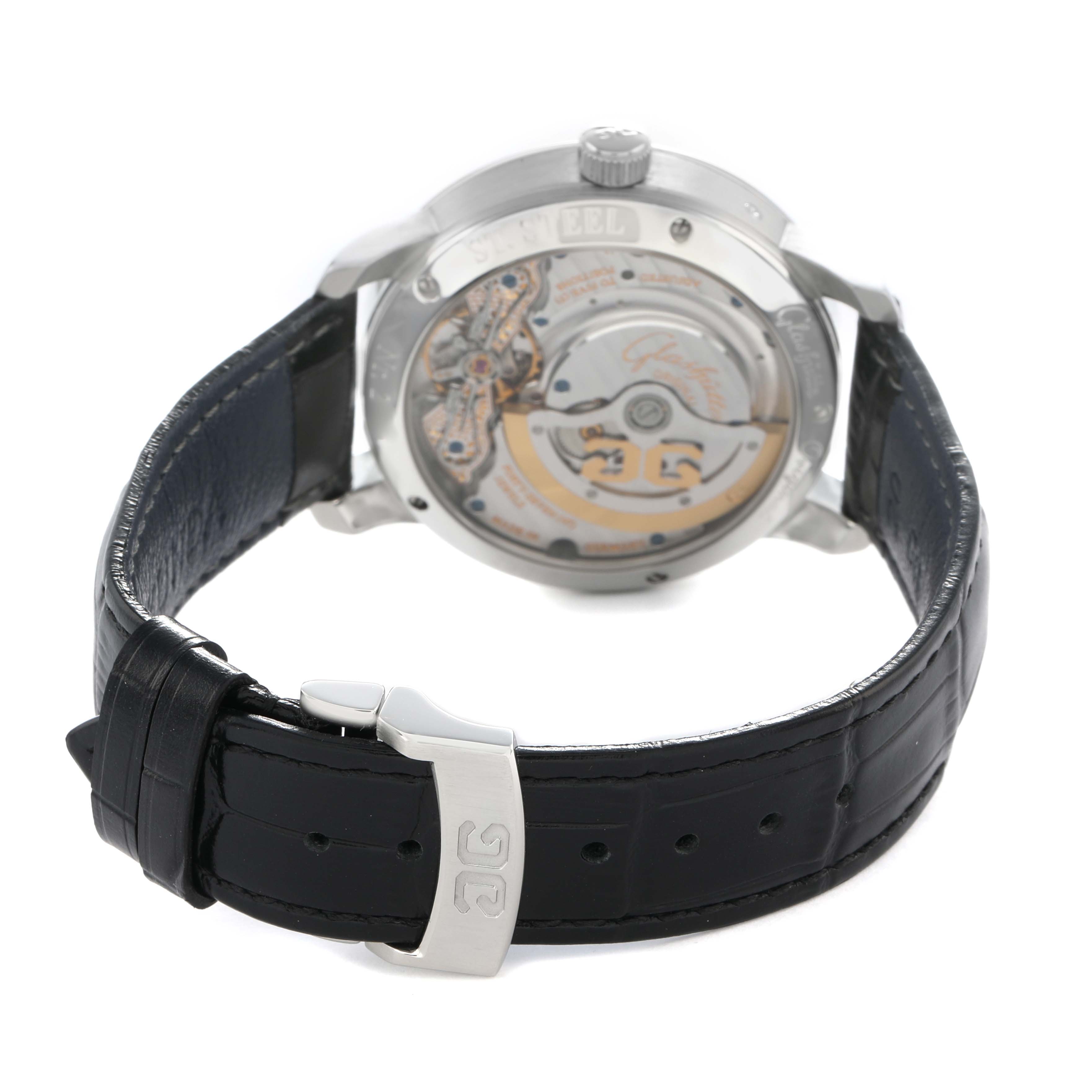 The image shows the back of the Glashütte Pano watch, highlighting its transparent case back and movement, with a leather strap visible.