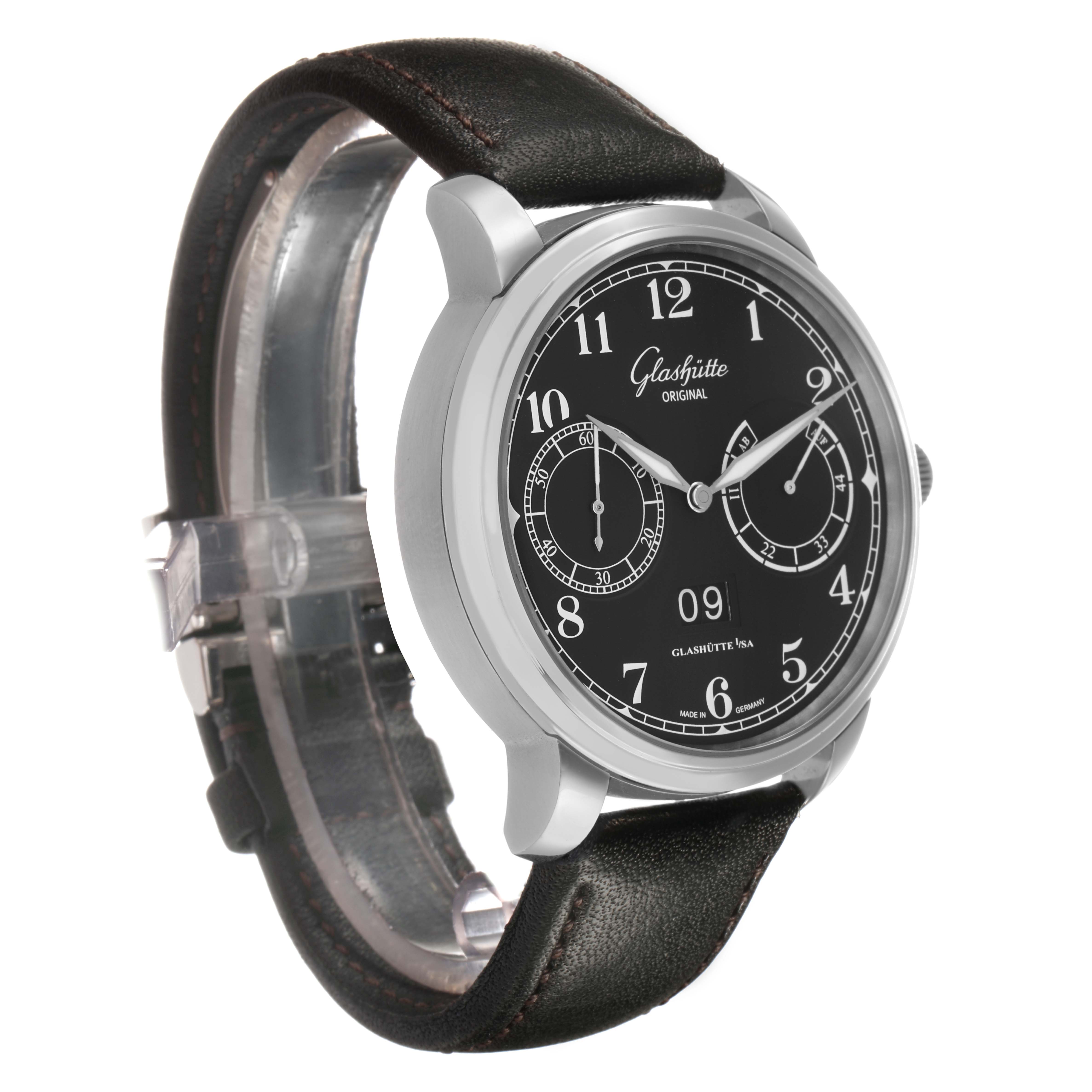 The Glashütte Senator watch is shown at a three-quarter angle, highlighting the black dial, silver hands, and leather strap.
