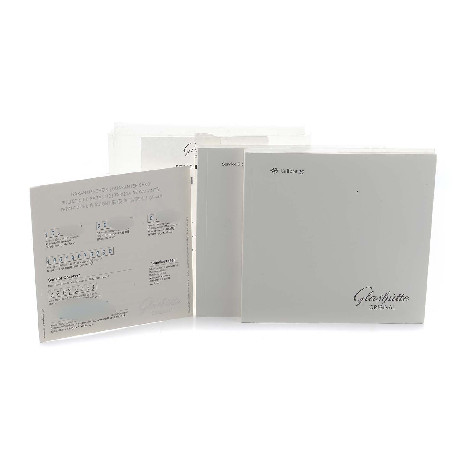 The image shows documentation for the Glashütte Senator, including a guarantee card and manuals, displayed at a close frontal angle.
