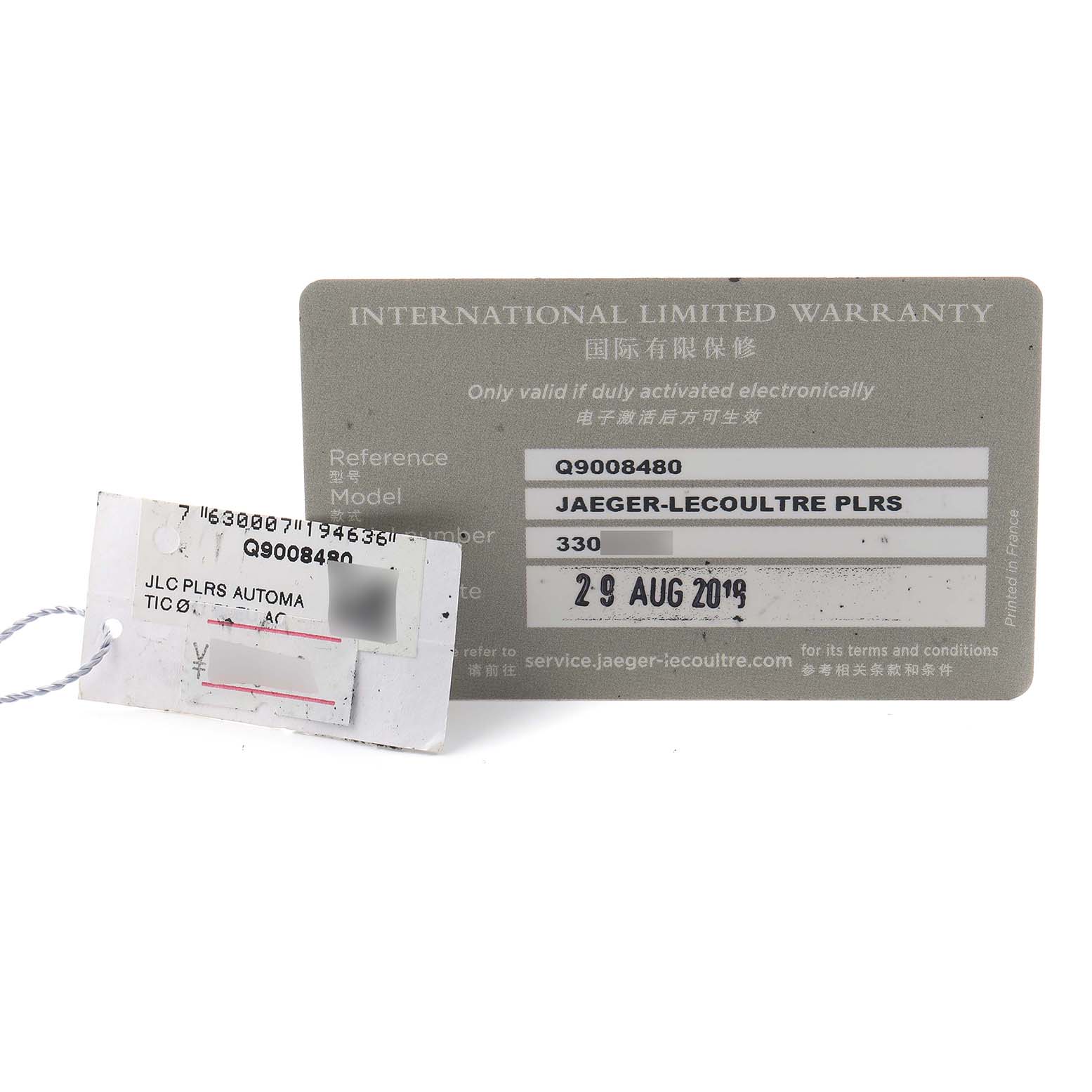 The image shows the international warranty card and tag for the Jaeger-LeCoultre Polaris model, displayed at an angle.