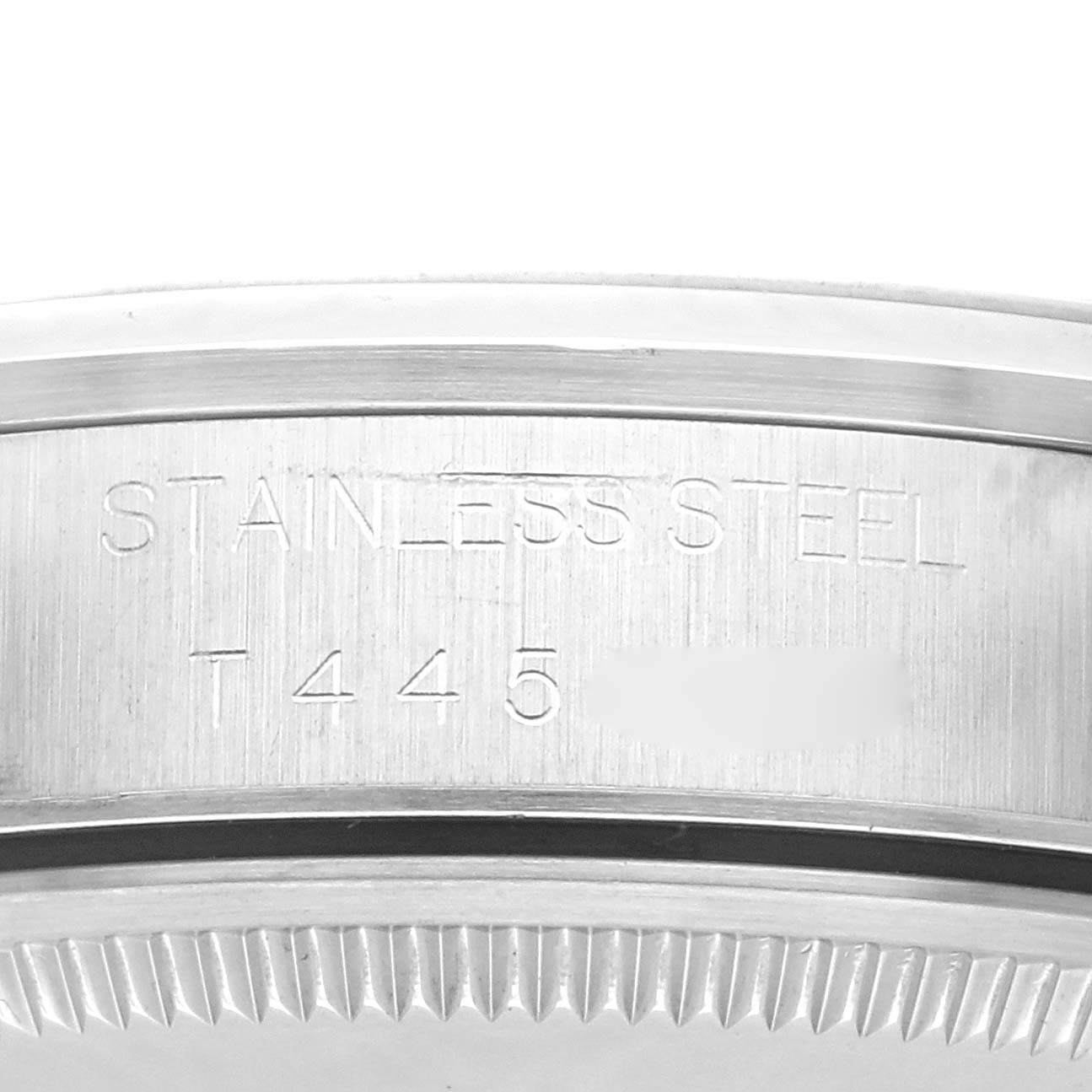 The image shows a close-up side view of the case of a Rolex Air-King 14000 Men's Stainless Steel Blue Dial 14000 Men's Stainless Steel Blue Dial, highlighting the "STAINLESS STEEL" engraving.