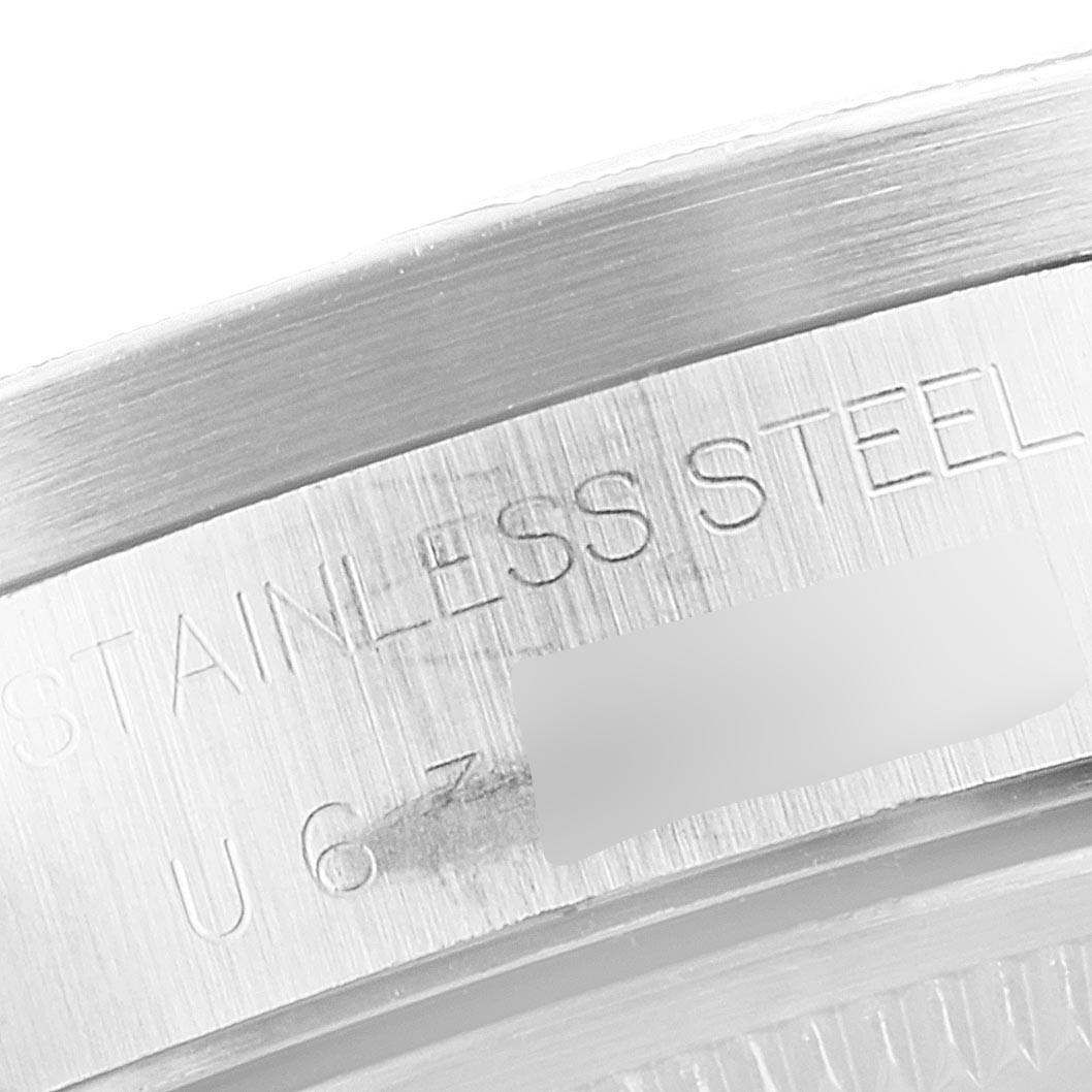 This image shows a close-up of the engraved stainless steel case back of a Rolex Date 15210 Men's Stainless Steel Blue Dial 15210 Men's Stainless Steel Blue Dial model watch.