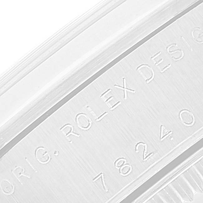This image shows a close-up of the serial number and engraved text on the case edge of a Mid-Size model by Rolex.