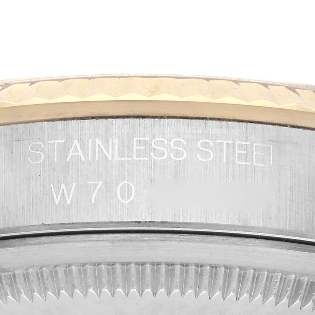 The image shows a close-up of the side engraving on a Rolex Datejust 16233 Men's Steel and Gold (two tone) Champagne Dial 16233 Men's Steel and Gold (two tone) Champagne Dial watch case, highlighting the text "STAINLESS STEEL".