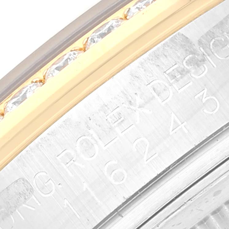 This close-up image shows the bezel and parts of the engraved inner ring of the Rolex Datejust 116243 Men's Steel and Gold (two tone) Black Dial 116243 Men's Steel and Gold (two tone) Black Dial watch.