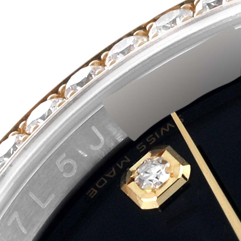This close-up image of the Rolex Datejust 116243 Men's Steel and Gold (two tone) Black Dial 116243 Men's Steel and Gold (two tone) Black Dial watch shows part of the diamond-encrusted bezel and a gold hour marker with a diamond.