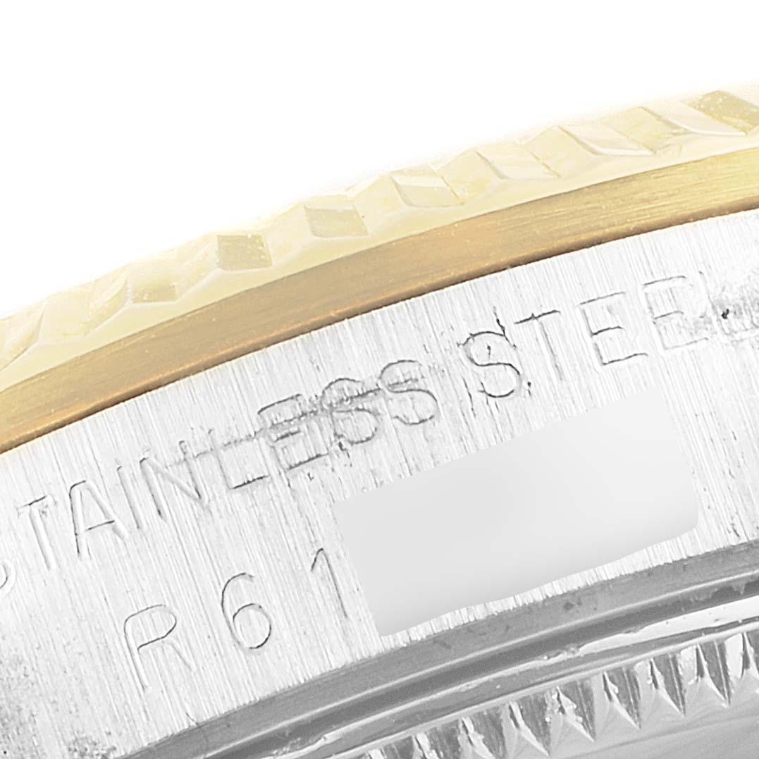 This image shows a close-up of the side of a Rolex Datejust 68273 Women's Steel and Gold (two tone) White Dial 68273 Women's Steel and Gold (two tone) White Dial watch, featuring parts of the bezel and engraved serial number.