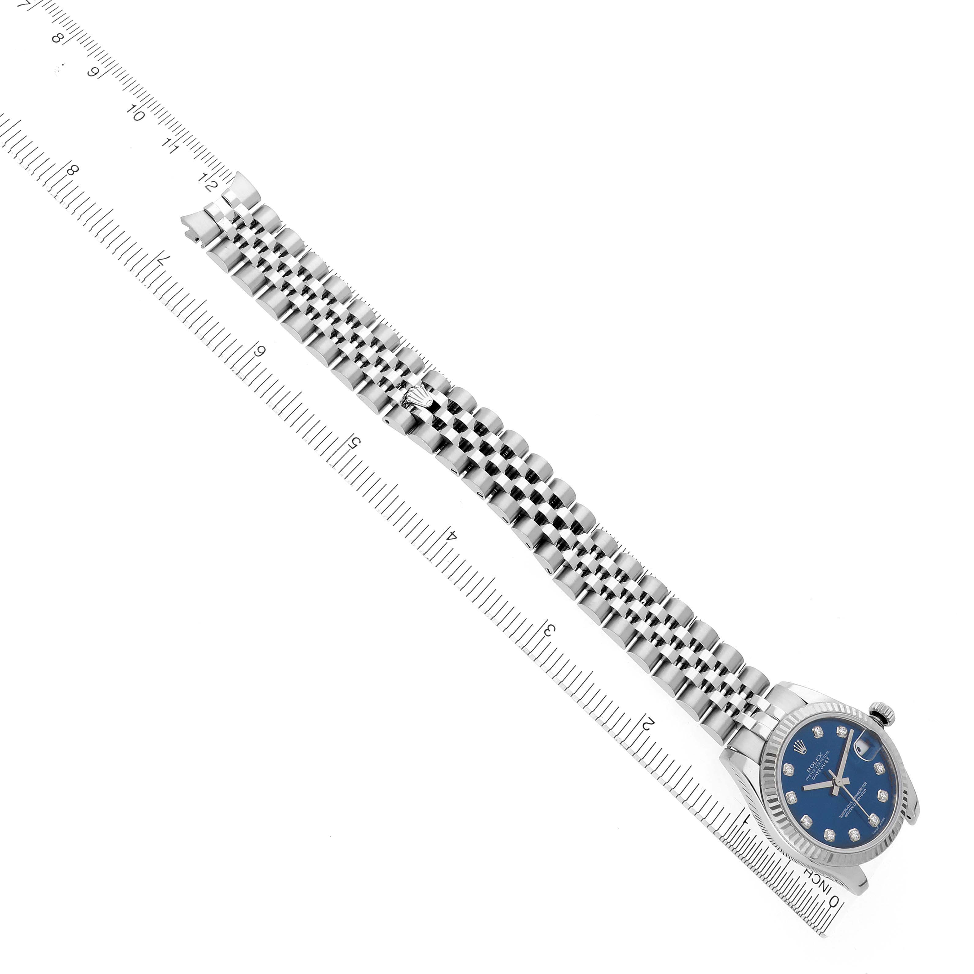 The image shows a Rolex Mid-Size 178274 Women's Stainless Steel Blue Dial 178274 Women's Stainless Steel Blue Dial watch at an angled top view, highlighting the bracelet and face alongside a ruler for scale.