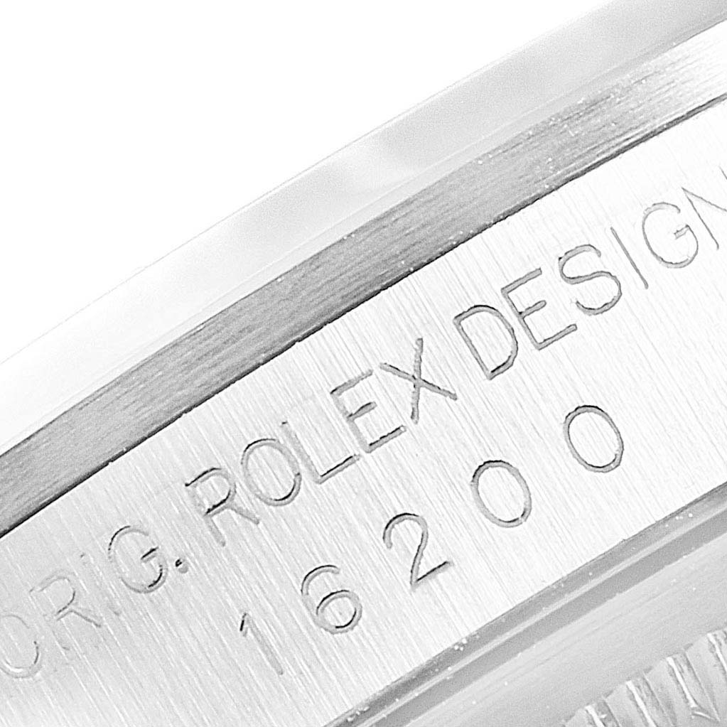 This close-up image shows the engraved edge of the bezel and case of a Rolex Datejust 16200 Men's Stainless Steel Silver Dial 16200 Men's Stainless Steel Silver Dial model.